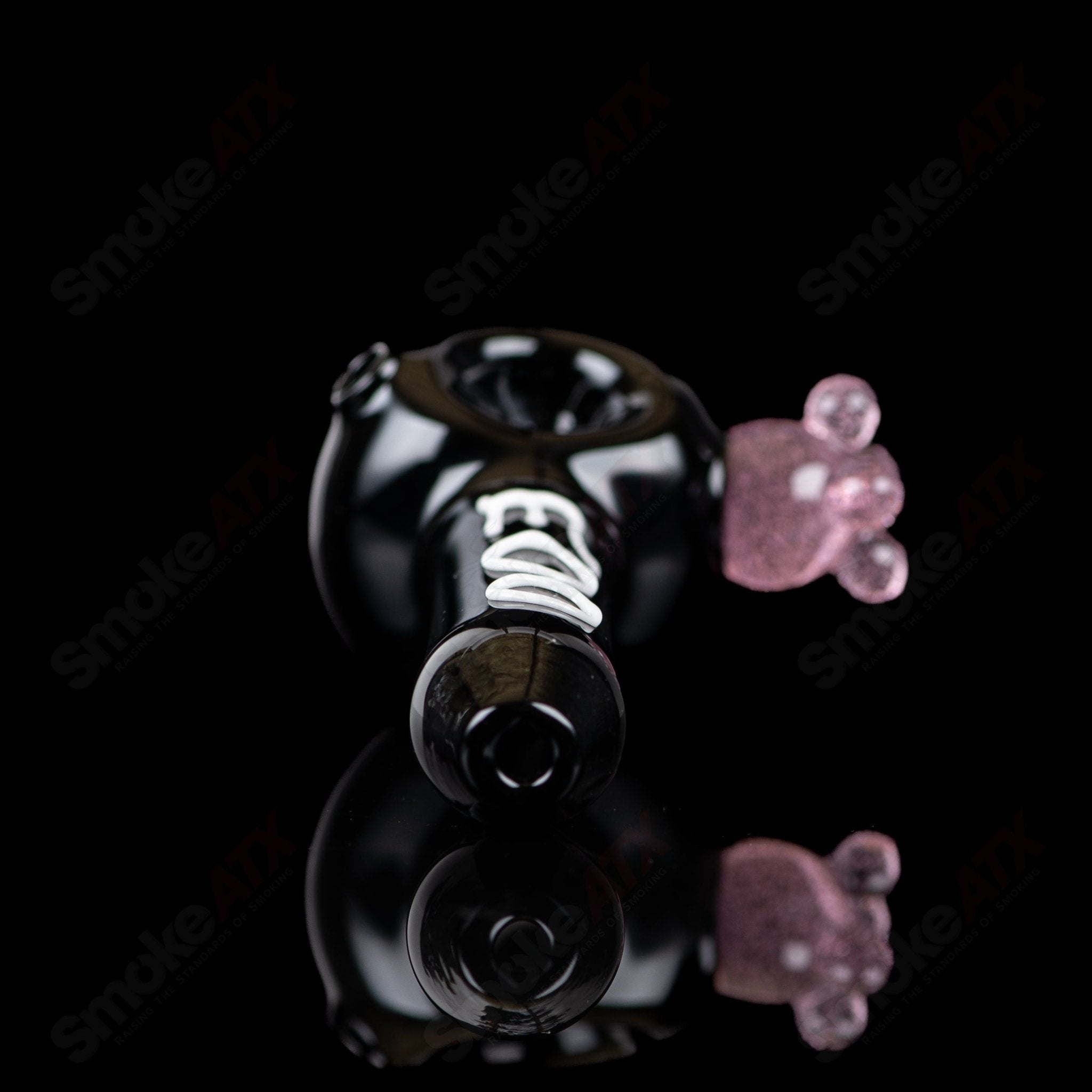 Black cow print glass spoon pipe by Adventures In Glass Blowing, detailed design with smooth bowl and mouthpiece for smoking.