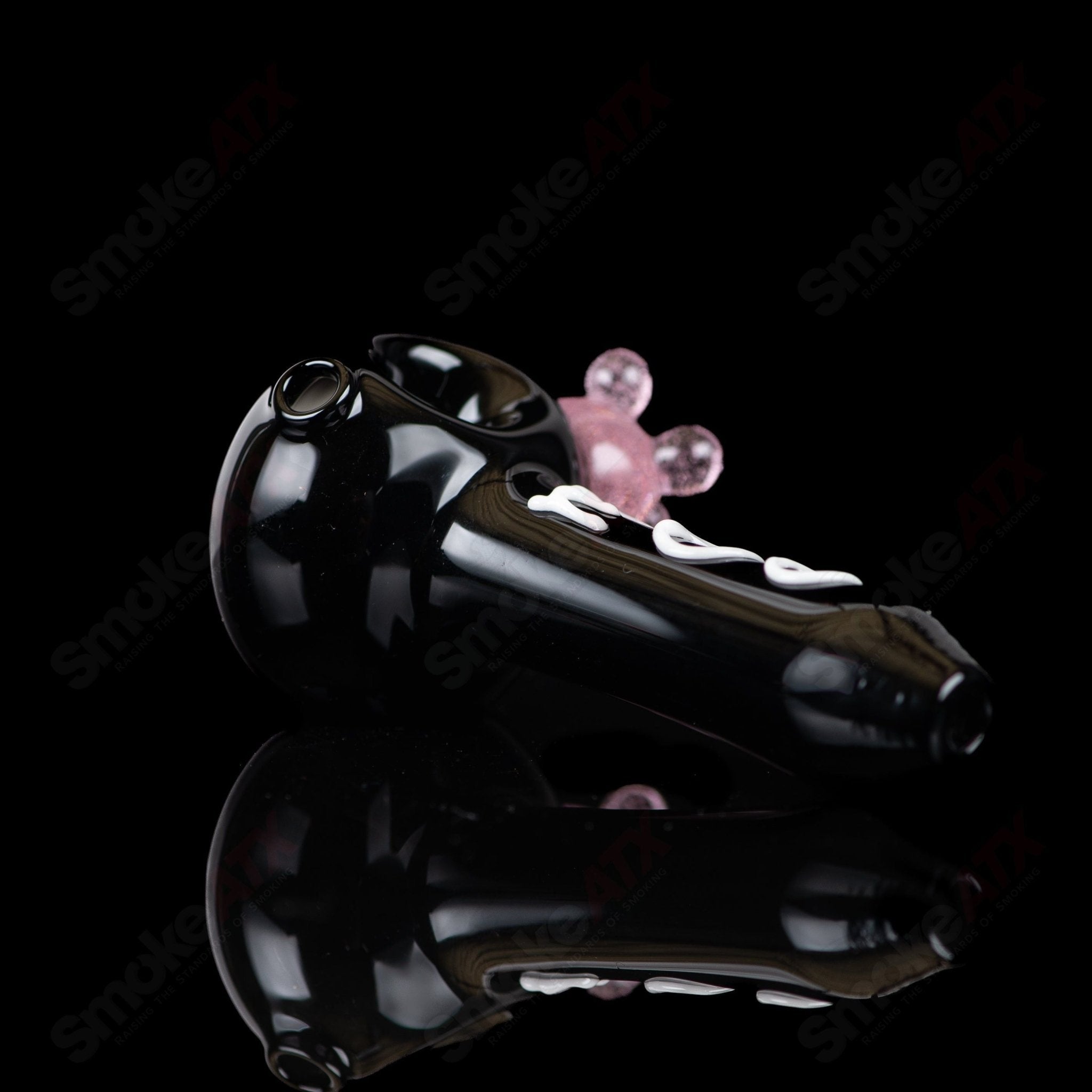 Black cow print glass spoon pipe by Adventures In Glass Blowing, featuring a sleek design and detailed cow print pattern.