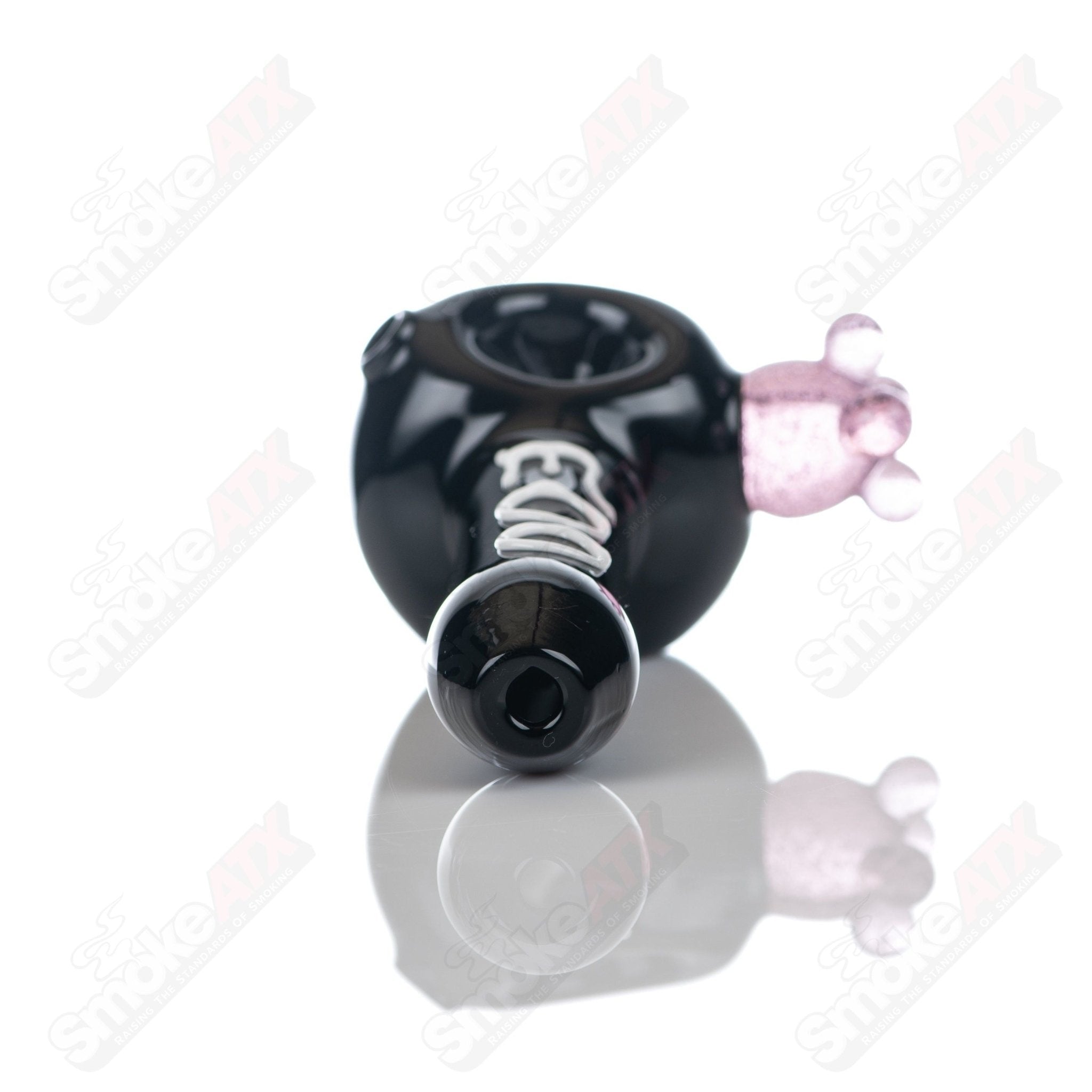 Black cow print glass spoon pipe by Adventures In Glass Blowing, featuring a detailed black and white cow pattern.