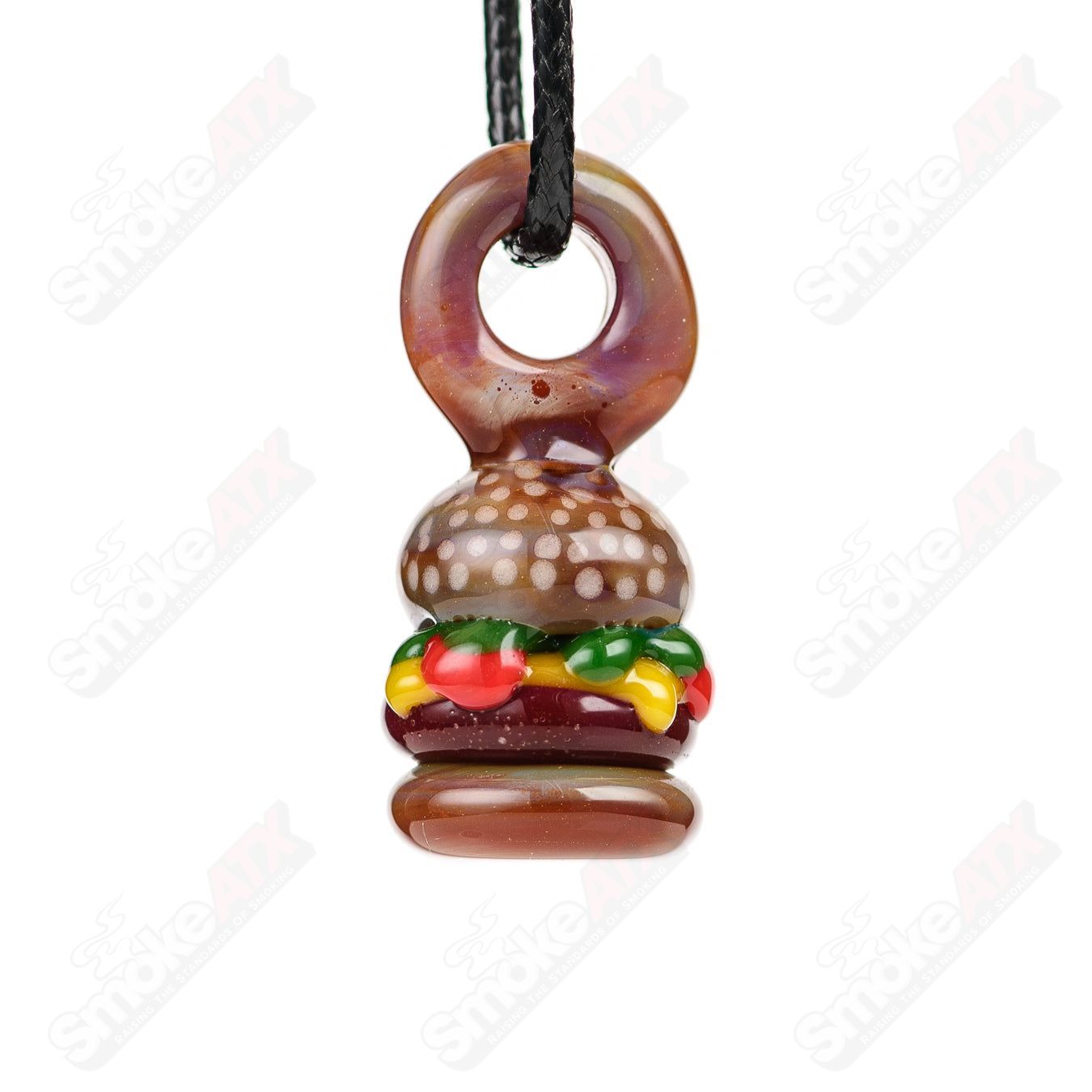 Sputnik Burger Pendant made of glass, featuring a realistic burger design, hangs as a stylish jewelry accessory.