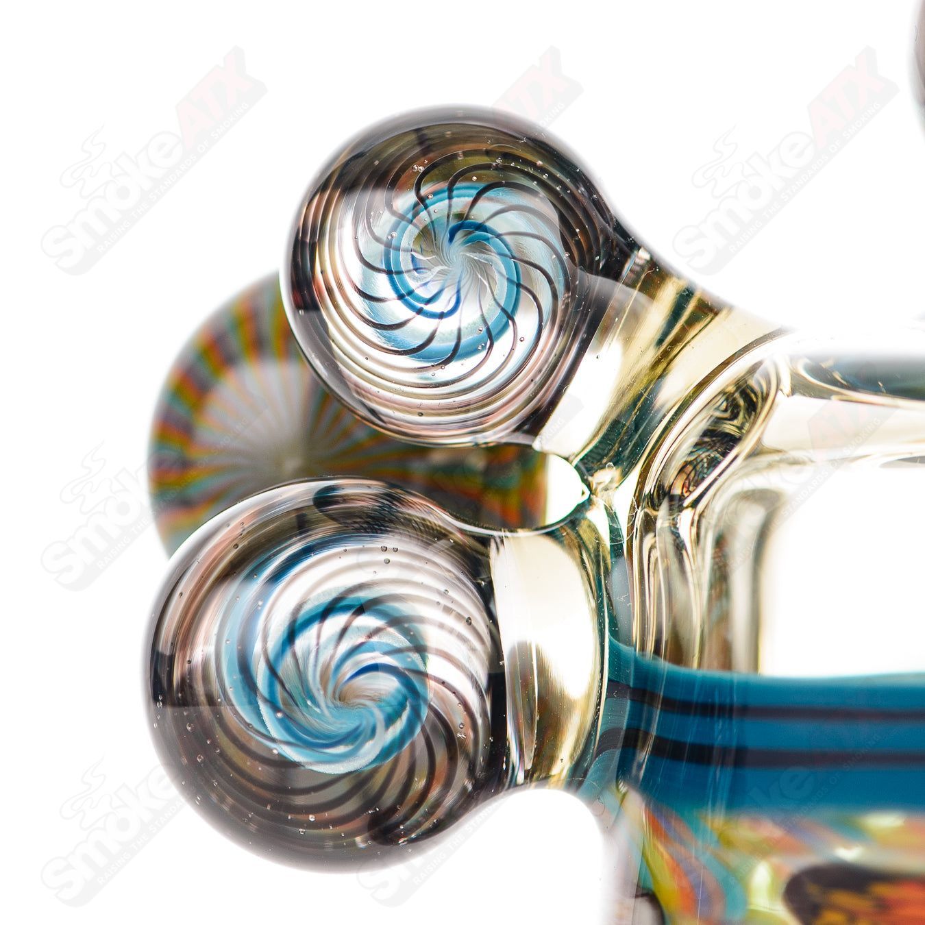 Coiled Latticello Milli Rig by Conversion Glass, a colorful heady glass concentrate rig with intricate coil design and clear glass accents.