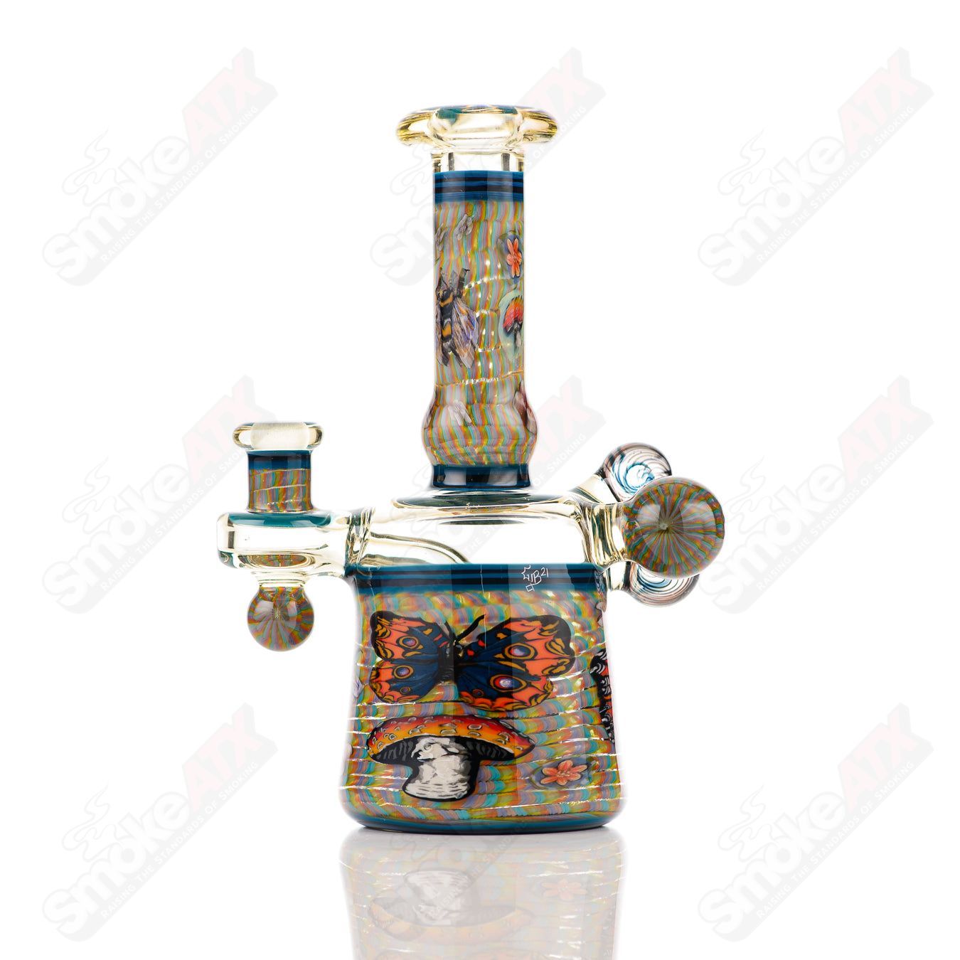 Coiled Latticello Milli Rig by Conversion Glass, a colorful heady glass concentrate rig with intricate coil design and artistic glasswork.