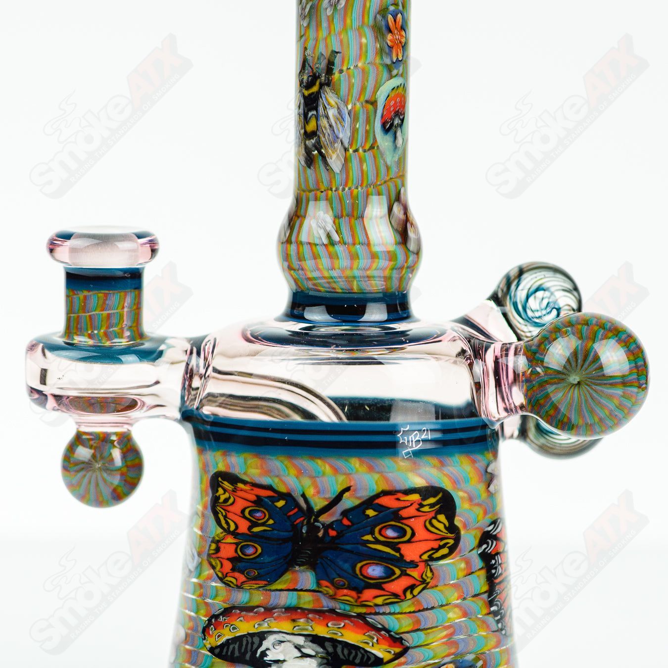 Coiled Latticello Milli Rig by Conversion Glass, a colorful heady glass concentrate rig with intricate coil design and handcrafted details.