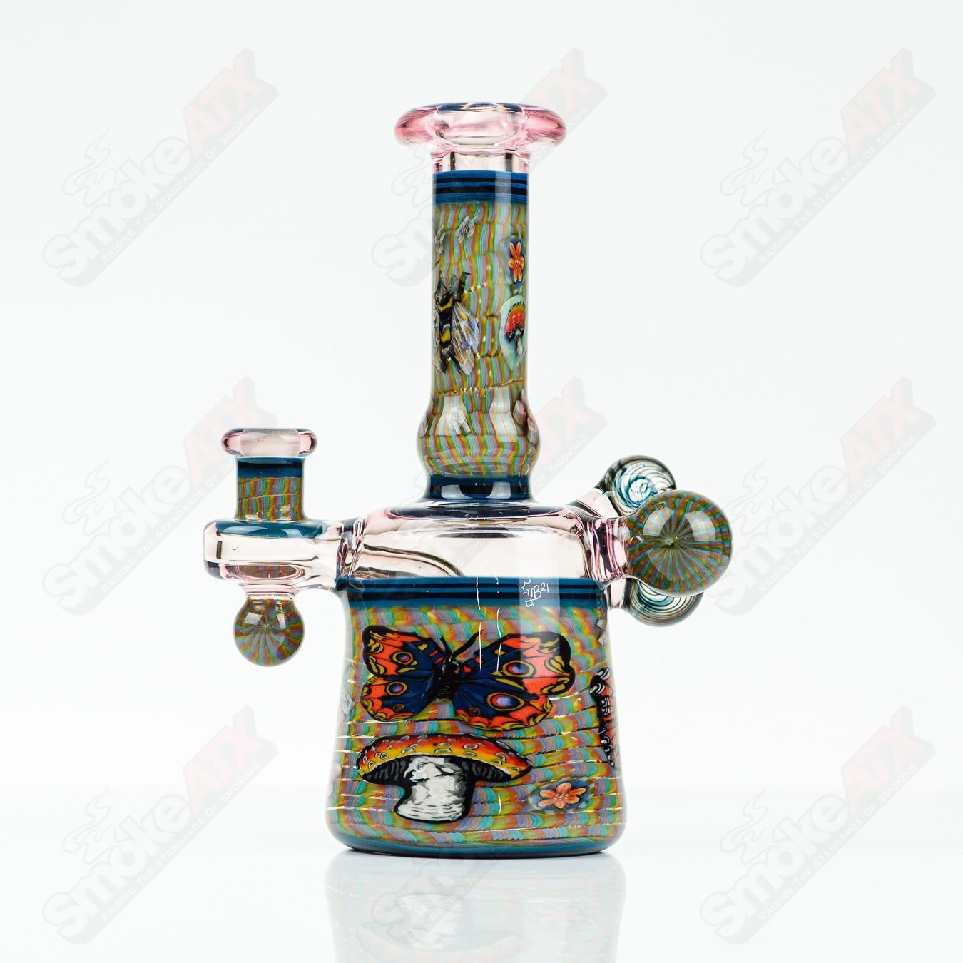 Coiled Latticello Milli Rig by Conversion Glass, a colorful heady glass concentrate rig with intricate coil design and vibrant glasswork.
