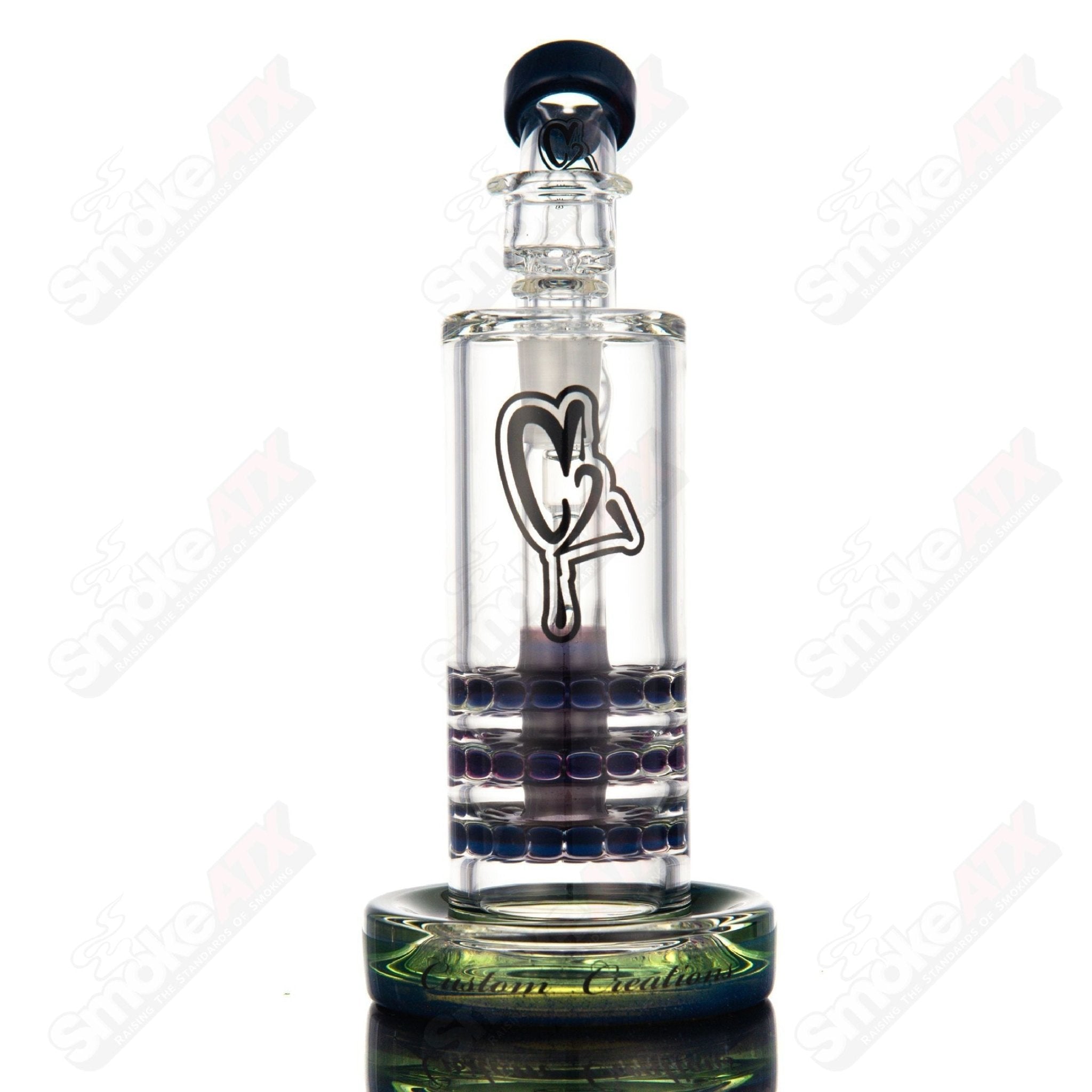 Color 50mm triple ratchet bent neck glass bubbler by C2 Custom Creations, featuring a vibrant design and curved mouthpiece.