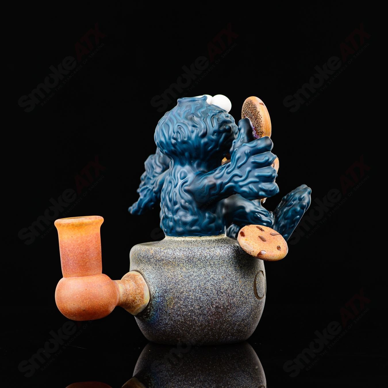 Colorful Cookie Monster Morrison glass concentrate rig by Robert Morrison with detailed cartoon character design.