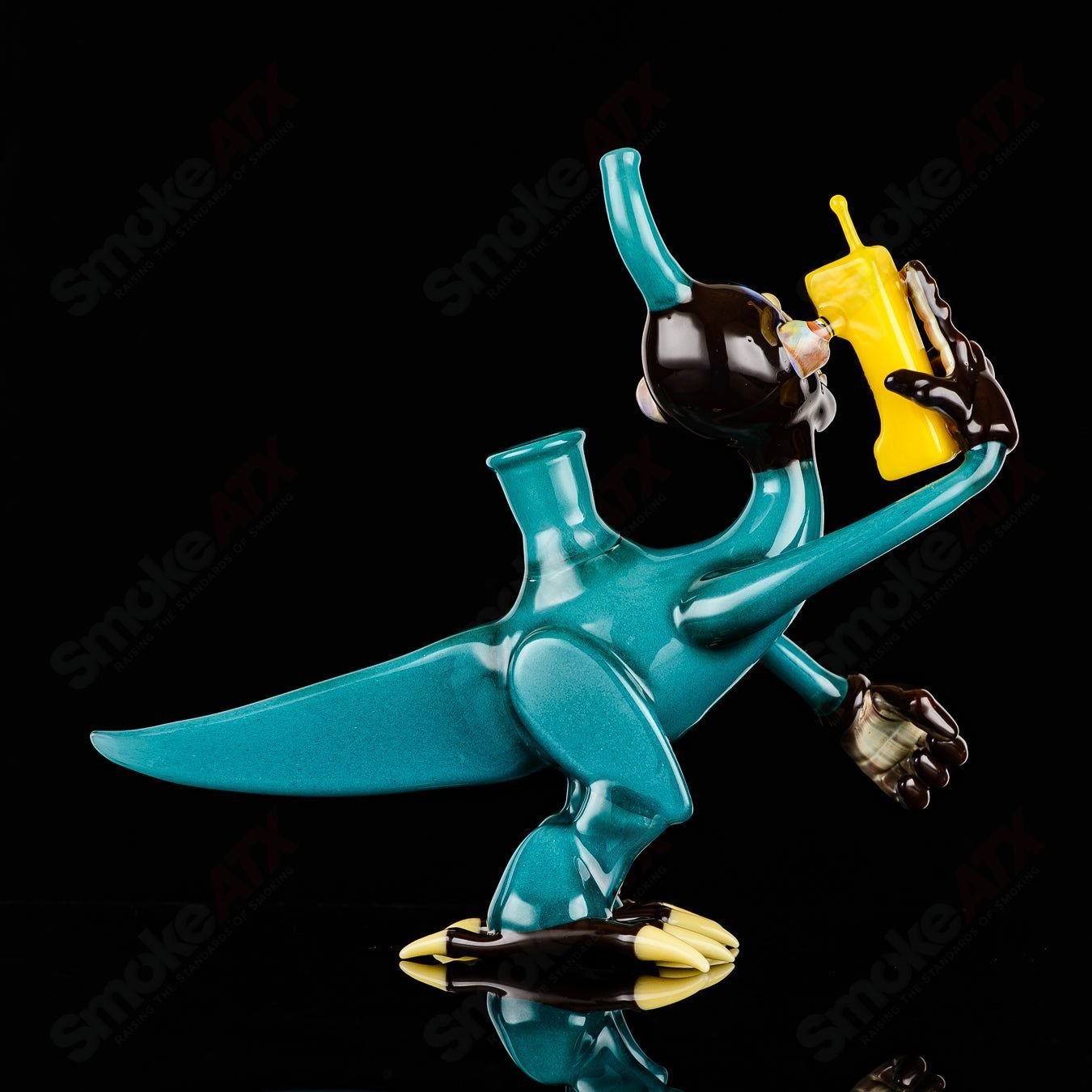 Elbo Glass Coyle x Elbo Dino Monkey heady glass concentrate rig with detailed dinosaur and monkey design, clear glass construction.