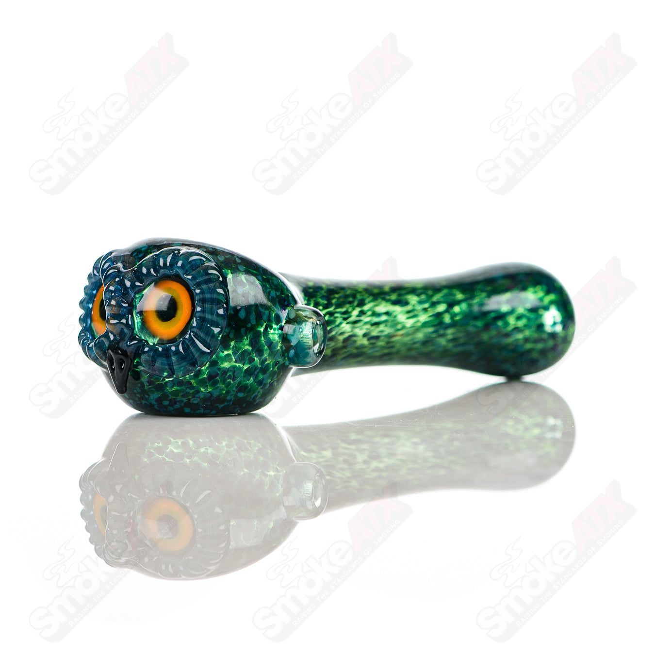 Cyan spotted owl glass spoon pipe by Four Winds Flameworks with detailed owl design and vibrant blue accents.