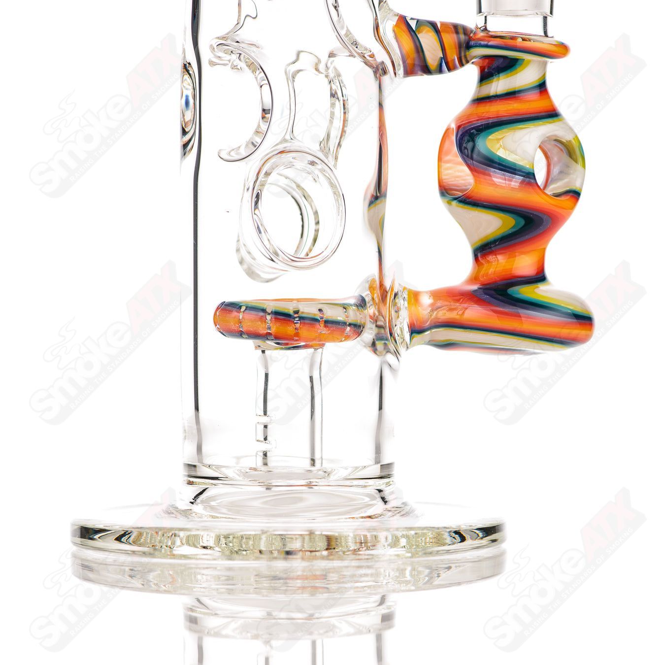 Glass donut-shaped bubbler rig by Texas Hot Glass, featuring a colorful donut ball design and clear glass accents.