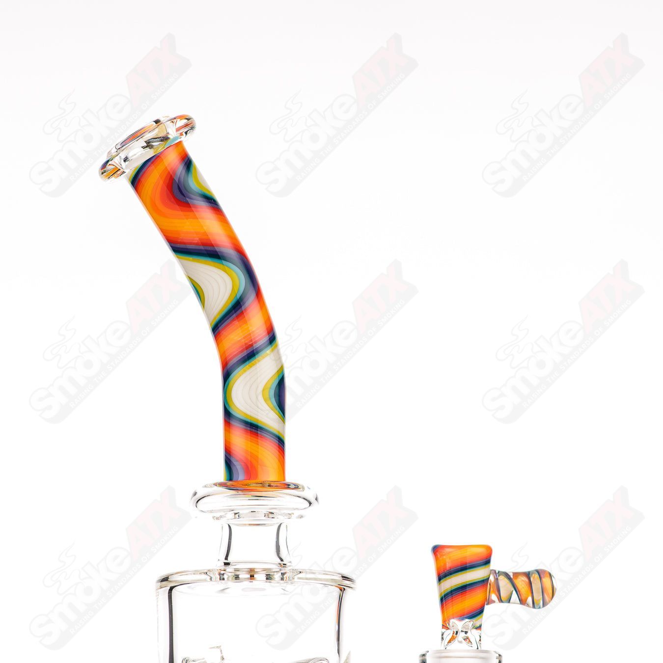 Glass donut-shaped bubbler rig by Texas Hot Glass featuring a colorful, intricate design with a spherical mouthpiece and sturdy base.