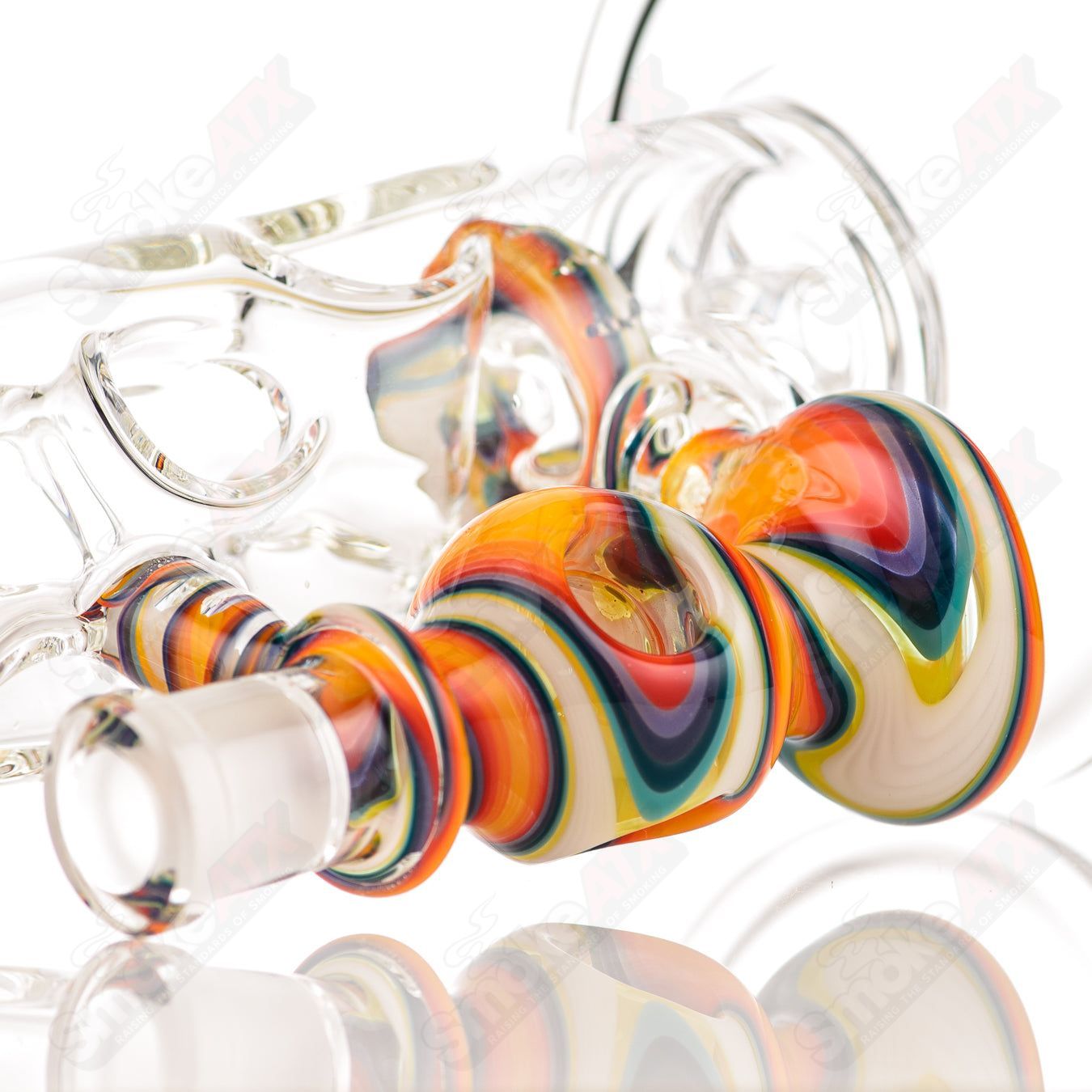 Glass donut ball rig by Texas Hot Glass, a colorful bubbler with a round donut-shaped design and intricate glasswork.