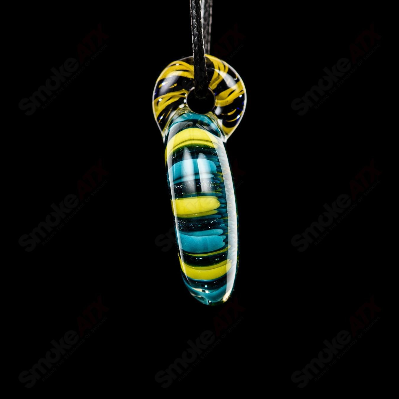 Glass Doticello Pendant Kit by Kit Kanz featuring colorful, handcrafted glass pendant with intricate design on a cord.