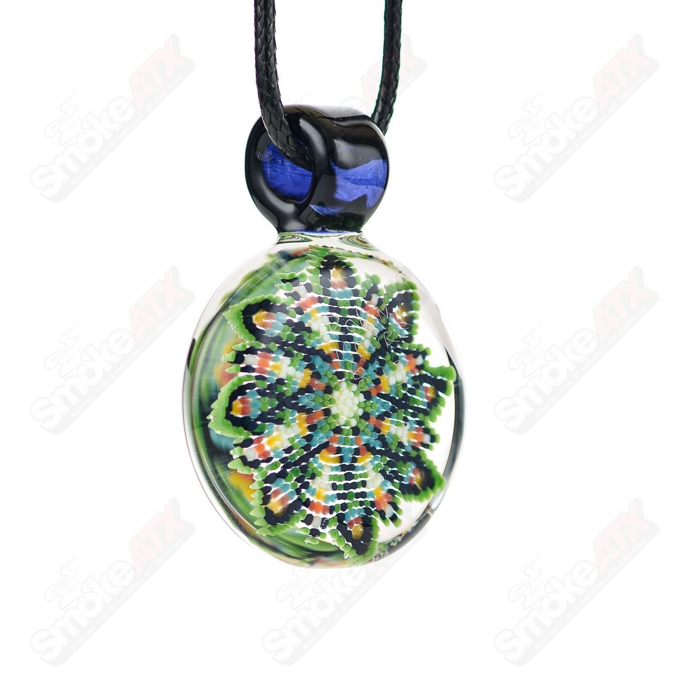 Glass dotwork pendant by Robin Moore featuring intricate design, hanging on a delicate chain.
