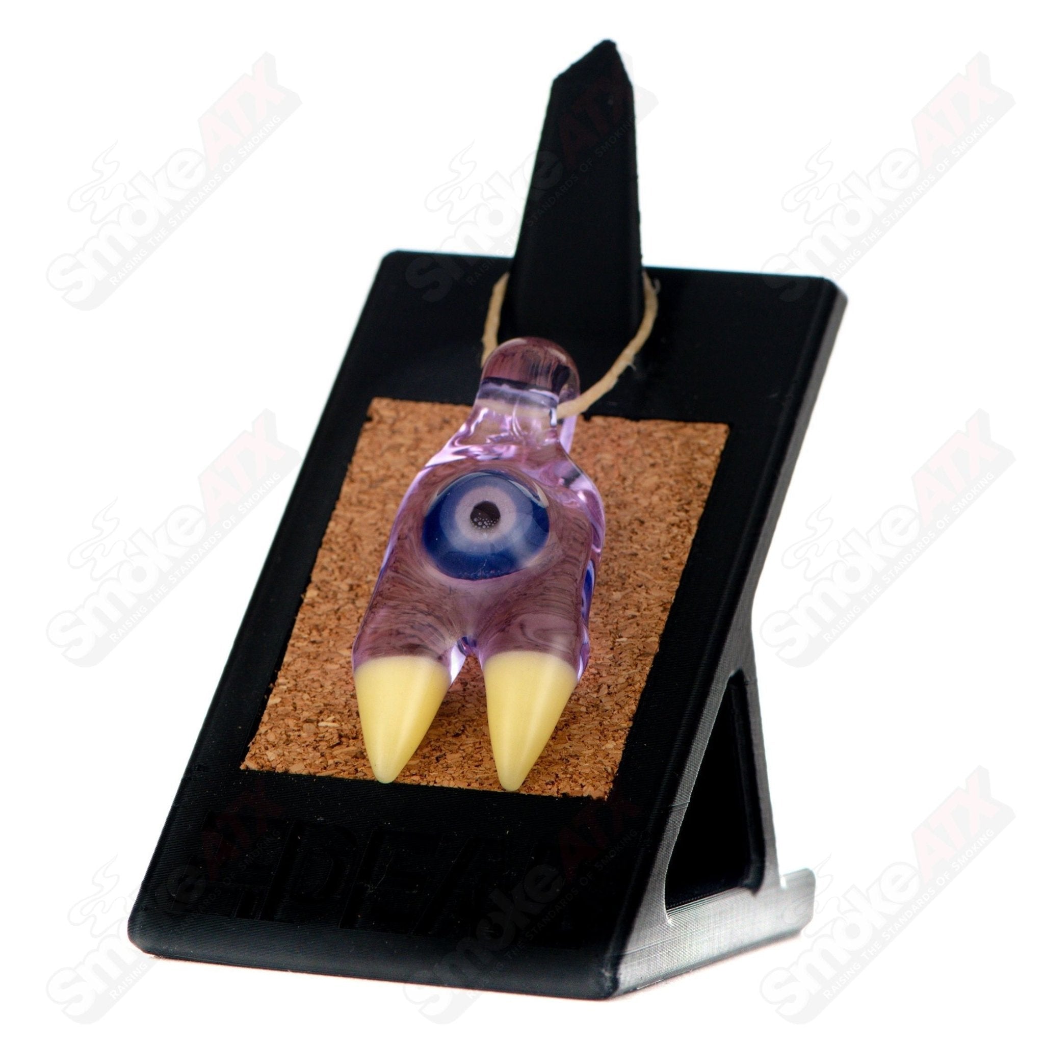 Elbo Glass Claw Pendant featuring intricate glass design and vibrant colors, hanging on a chain against a neutral background.