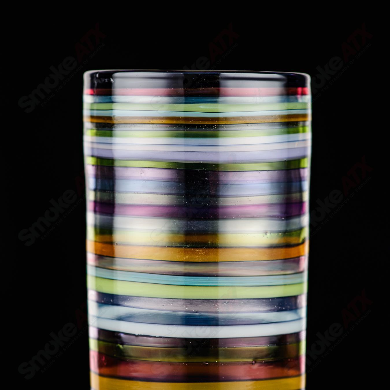 Encalmo pint glass by Freeek Glass, a heady glass cup with vibrant, colorful encalmo design and clear glass base.
