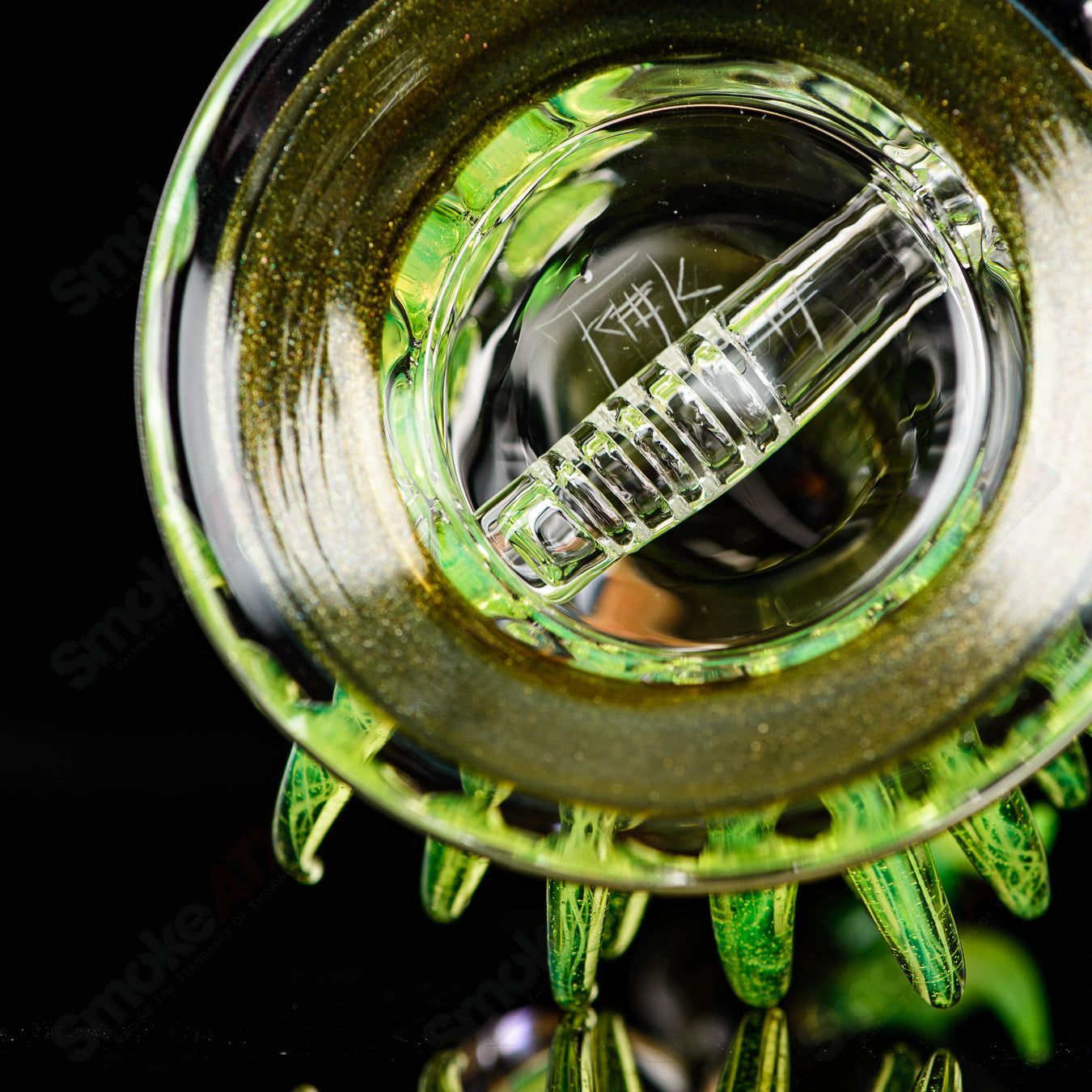 Fillacello DiscRig by Freeek Glass, a colorful heady glass concentrate rig with a unique disc-shaped design and vibrant Slyme color.