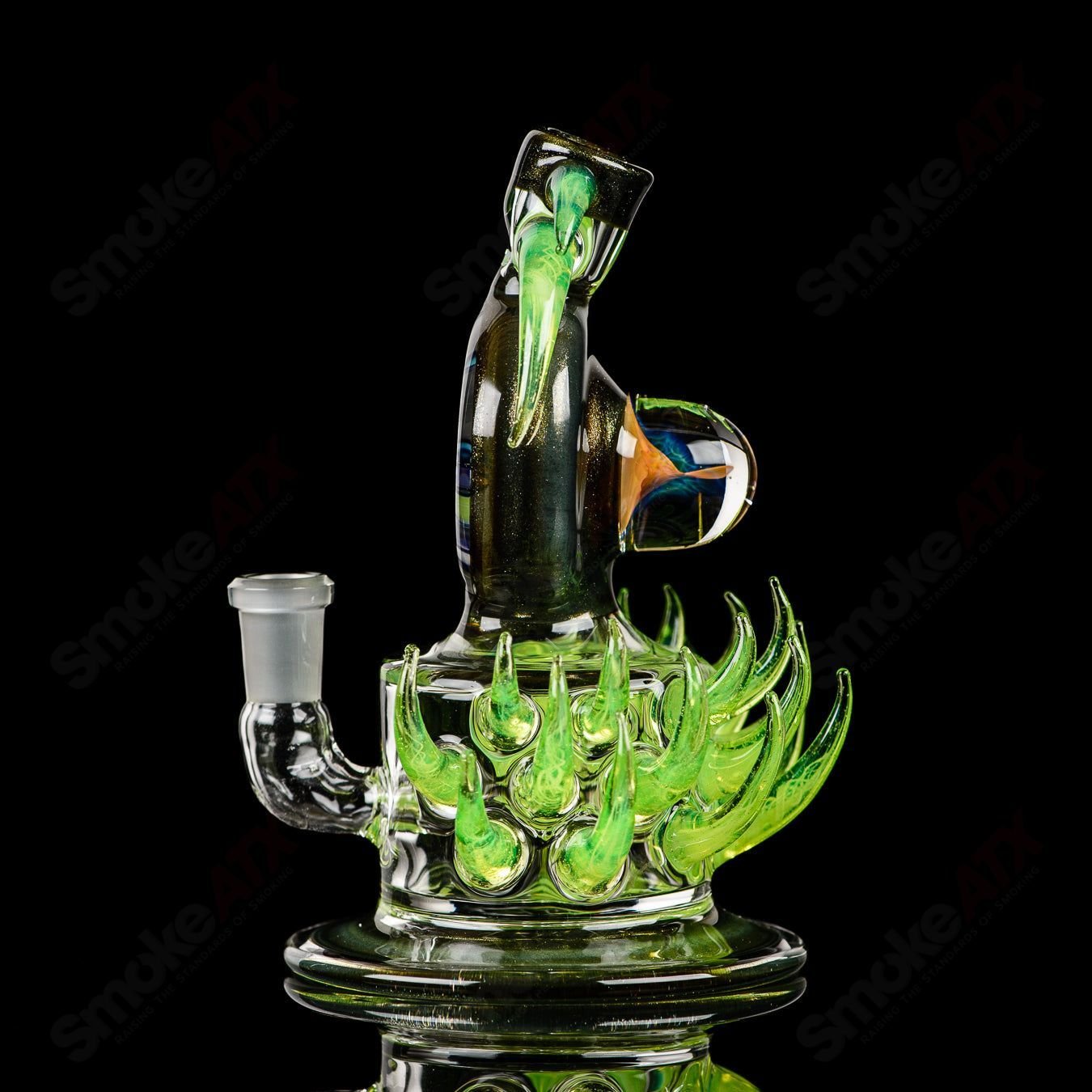 Fillacello DiscRig by Freeek Glass, a colorful heady glass concentrate rig with a distinctive disc design and vibrant Slyme color pattern.