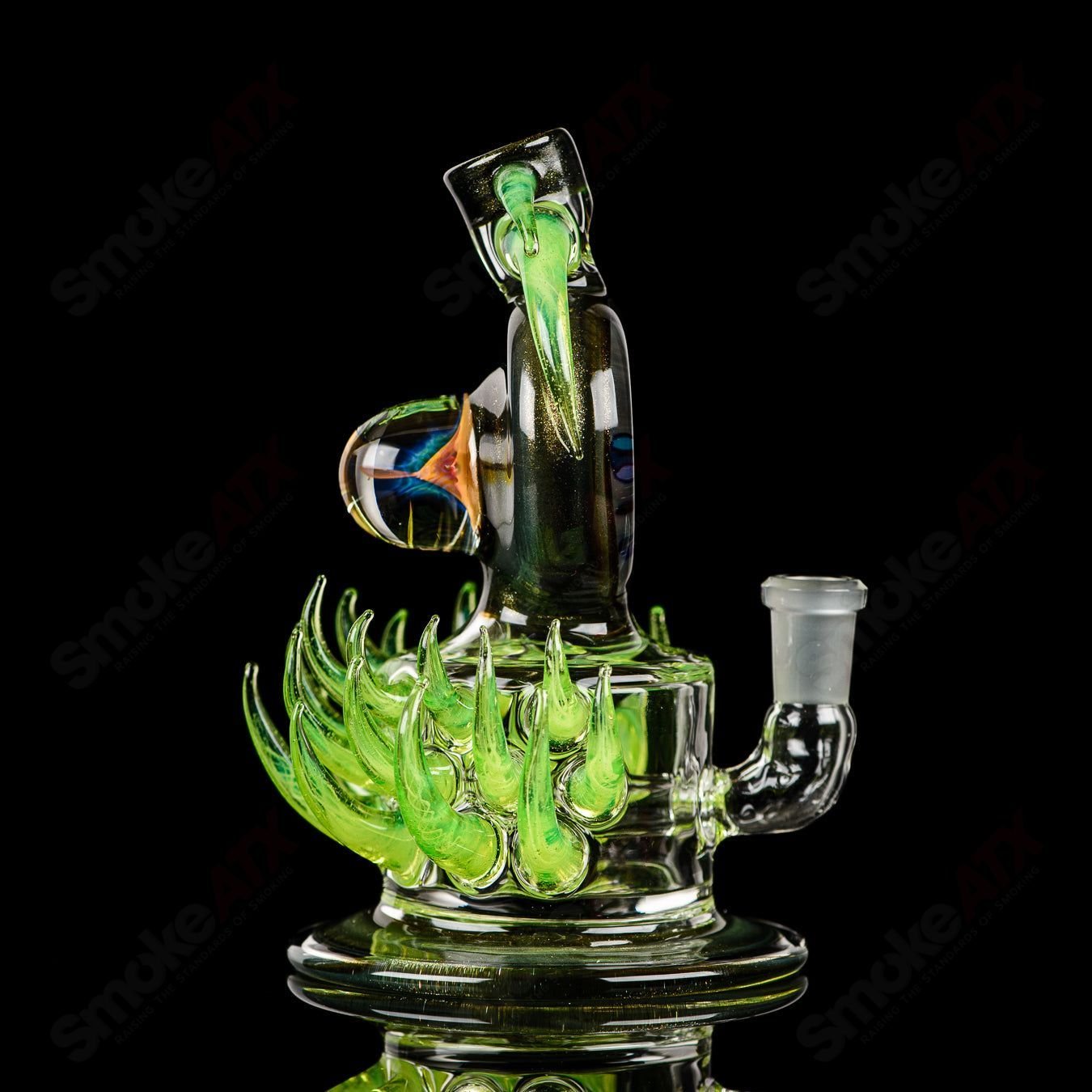 Fillacello DiscRig by Freeek Glass, a colorful heady glass concentrate rig with intricate Slyme design and disc-shaped base.