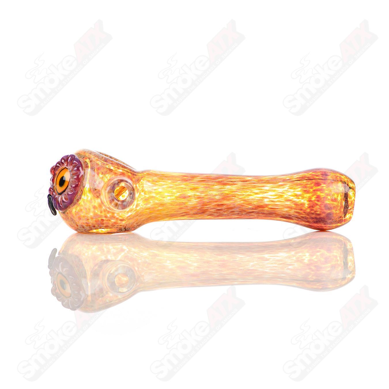 Fumed spotted owl glass spoon pipe by Four Winds Flameworks, detailed with intricate design and vibrant colors.