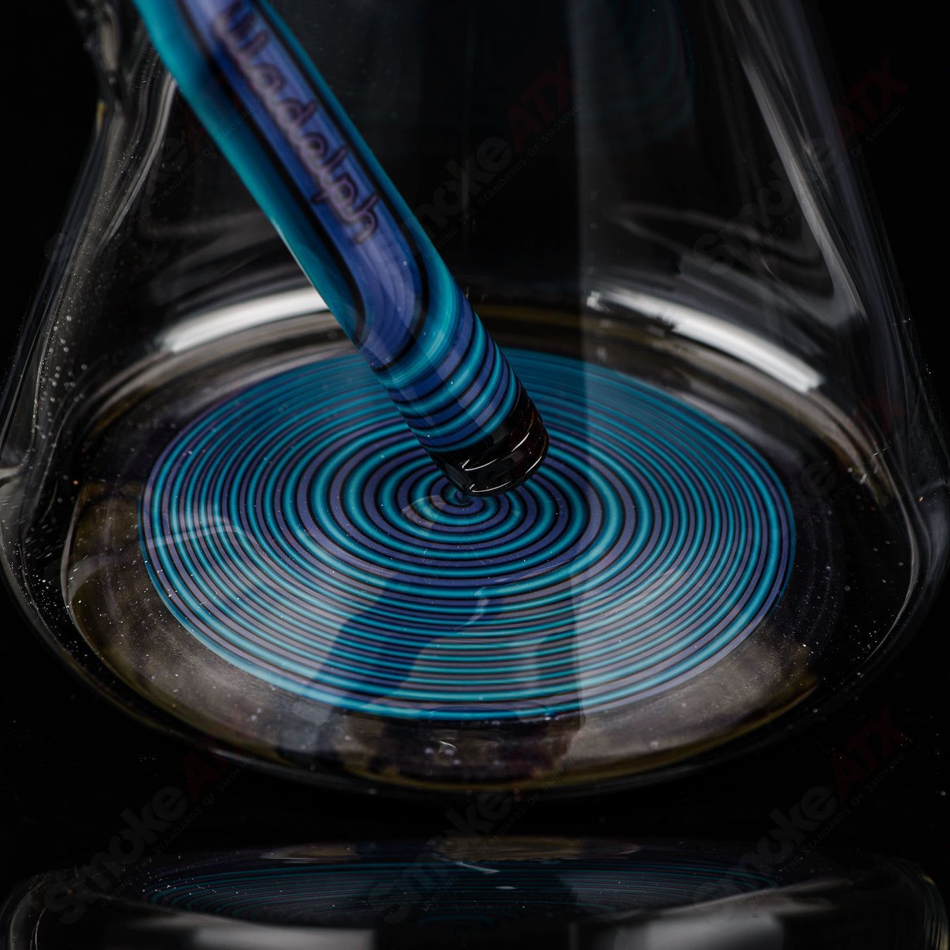Illadelph Purple and Aqua Jordan Beaker made of heady glass with vibrant purple and aqua accents and a beaker shape.