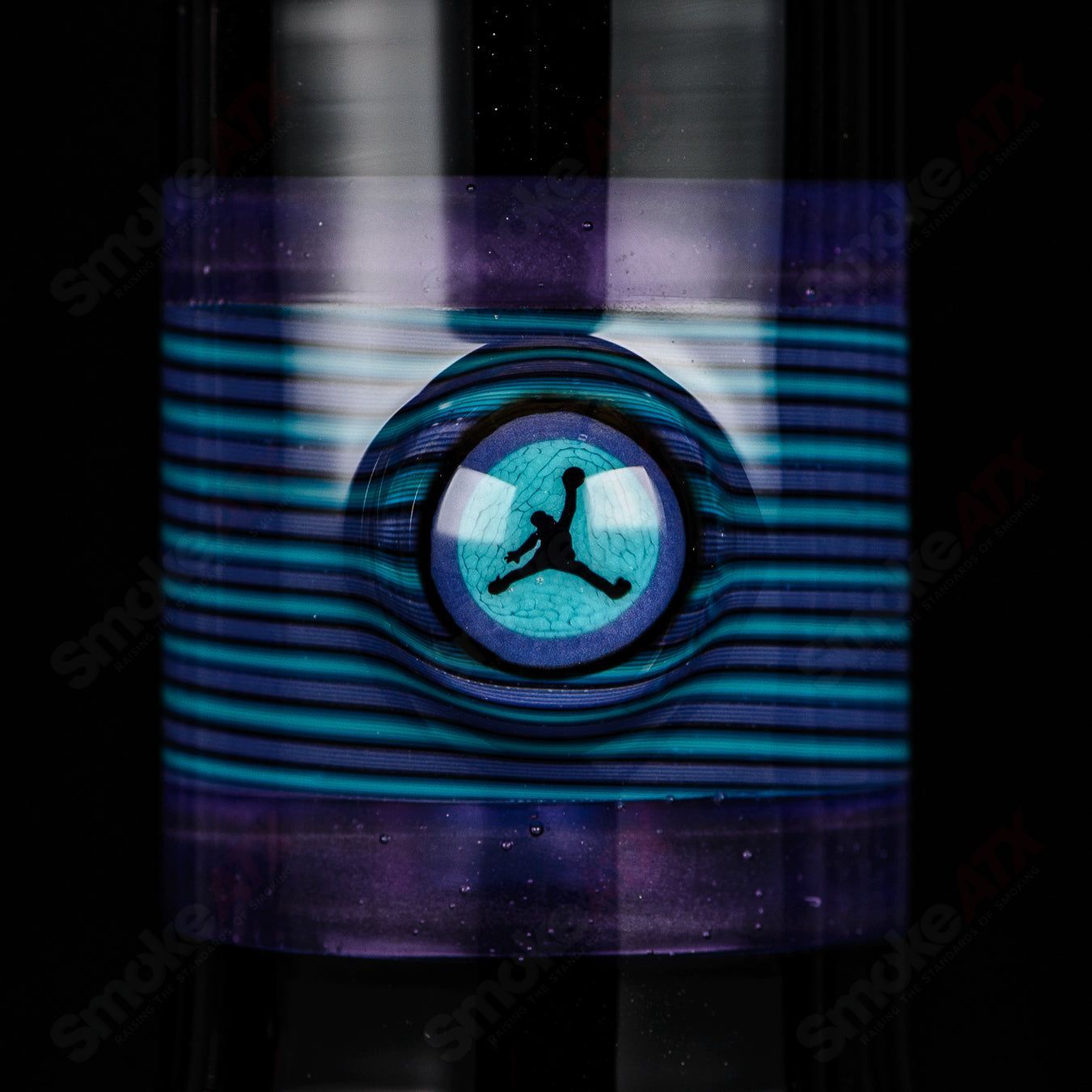 Illadelph purple and aqua Jordan beaker made of heady glass with colorful design and clear glass base, showcasing intricate craftsmanship.
