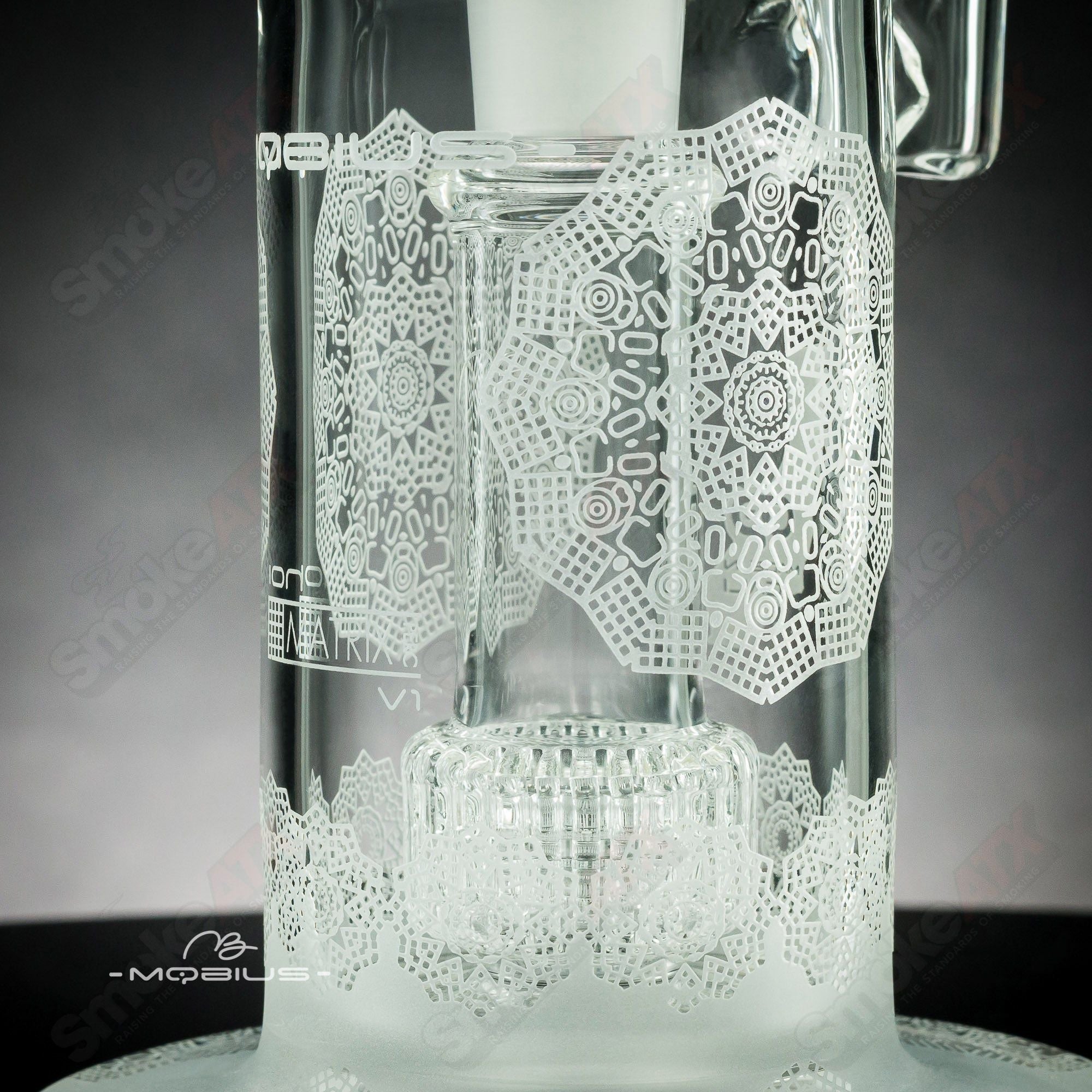 Mobius Ion Matrix V1 Coldwork Series #5 glass waterpipe with intricate design and clear glass body for smooth water filtration.