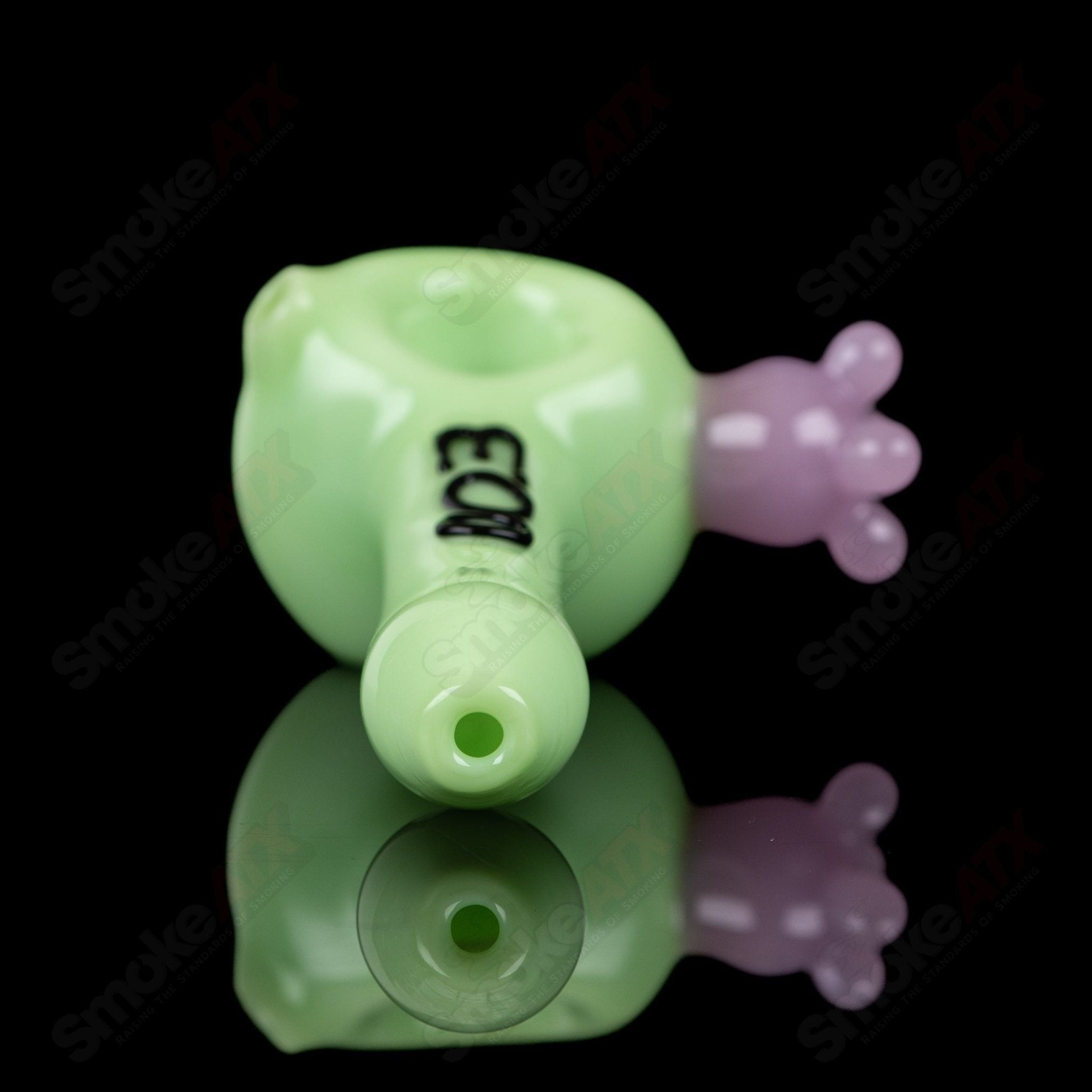 Glass kiwi cow print spoon pipe by Adventures In Glass Blowing, featuring vibrant green and cow pattern design.