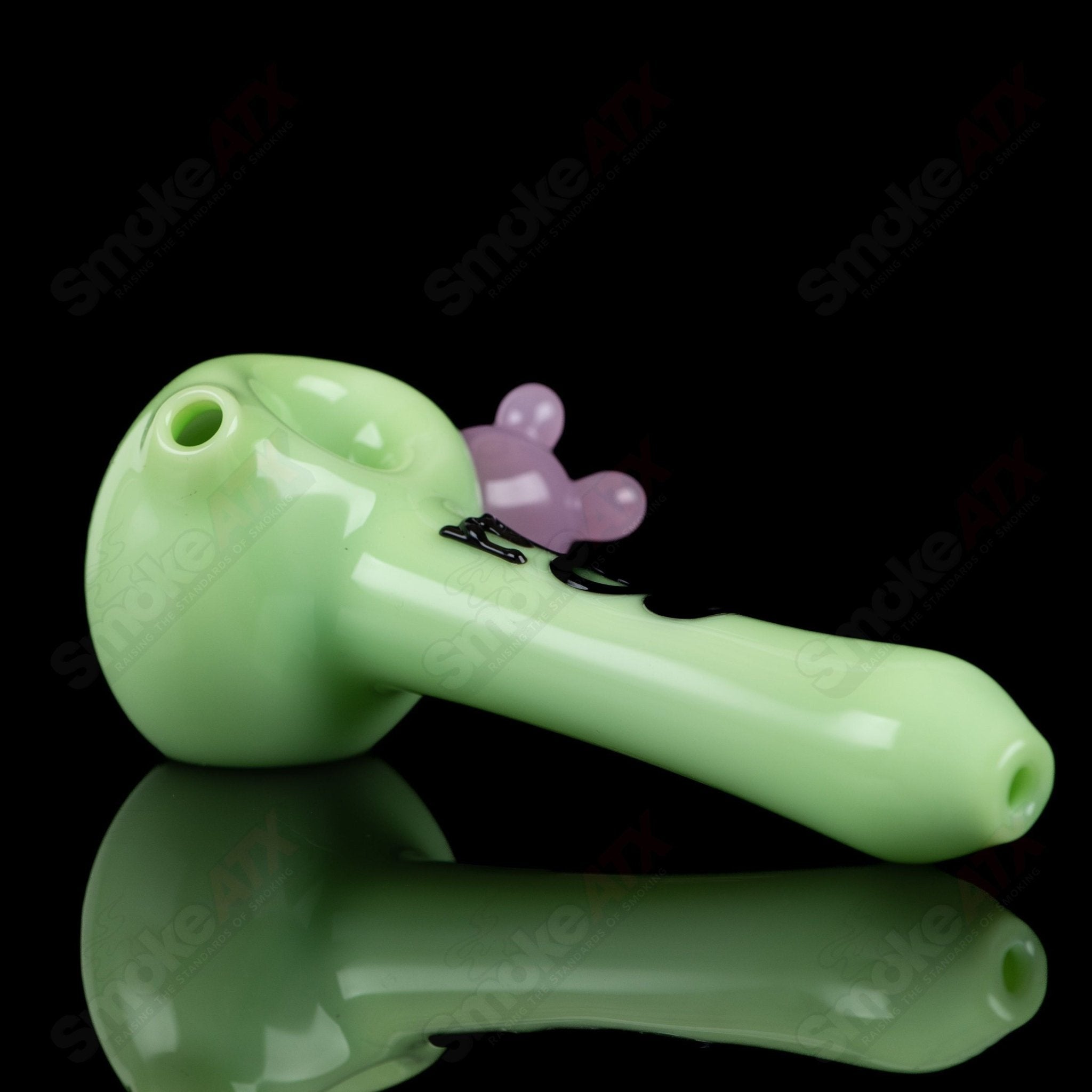 Glass spoon pipe with kiwi and cow print design by Adventures In Glass Blowing, showcasing colorful, detailed glass art.