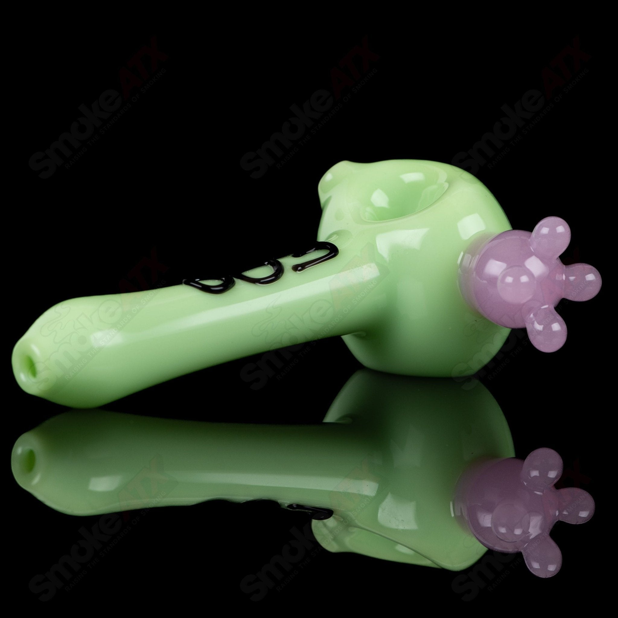 Glass spoon pipe with kiwi and cow print design by Adventures In Glass Blowing, showcasing intricate glass blowing craftsmanship.
