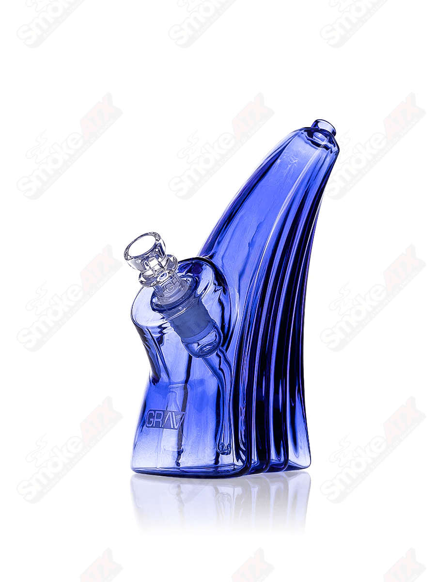 Light cobalt wave bubbler waterpipe by Grav, featuring a smooth glass design with swirling wave patterns for a stylish smoking experience.