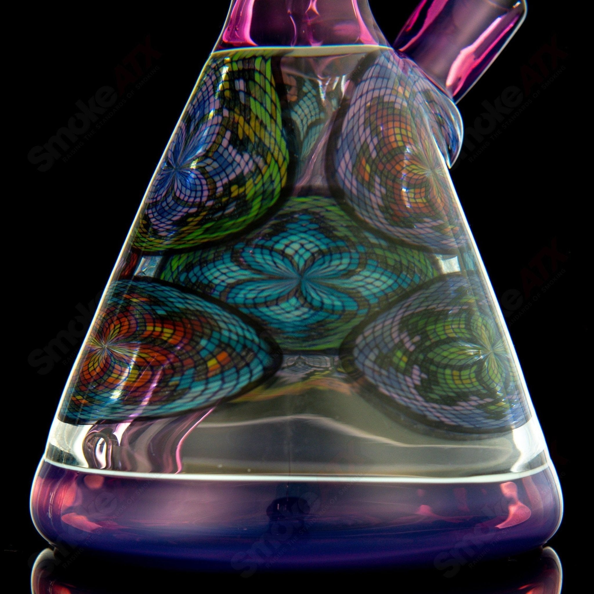 Multiple John W Glass Filla Beakers, colorful heady glass beakers with intricate designs, used for artistic smoking sessions.
