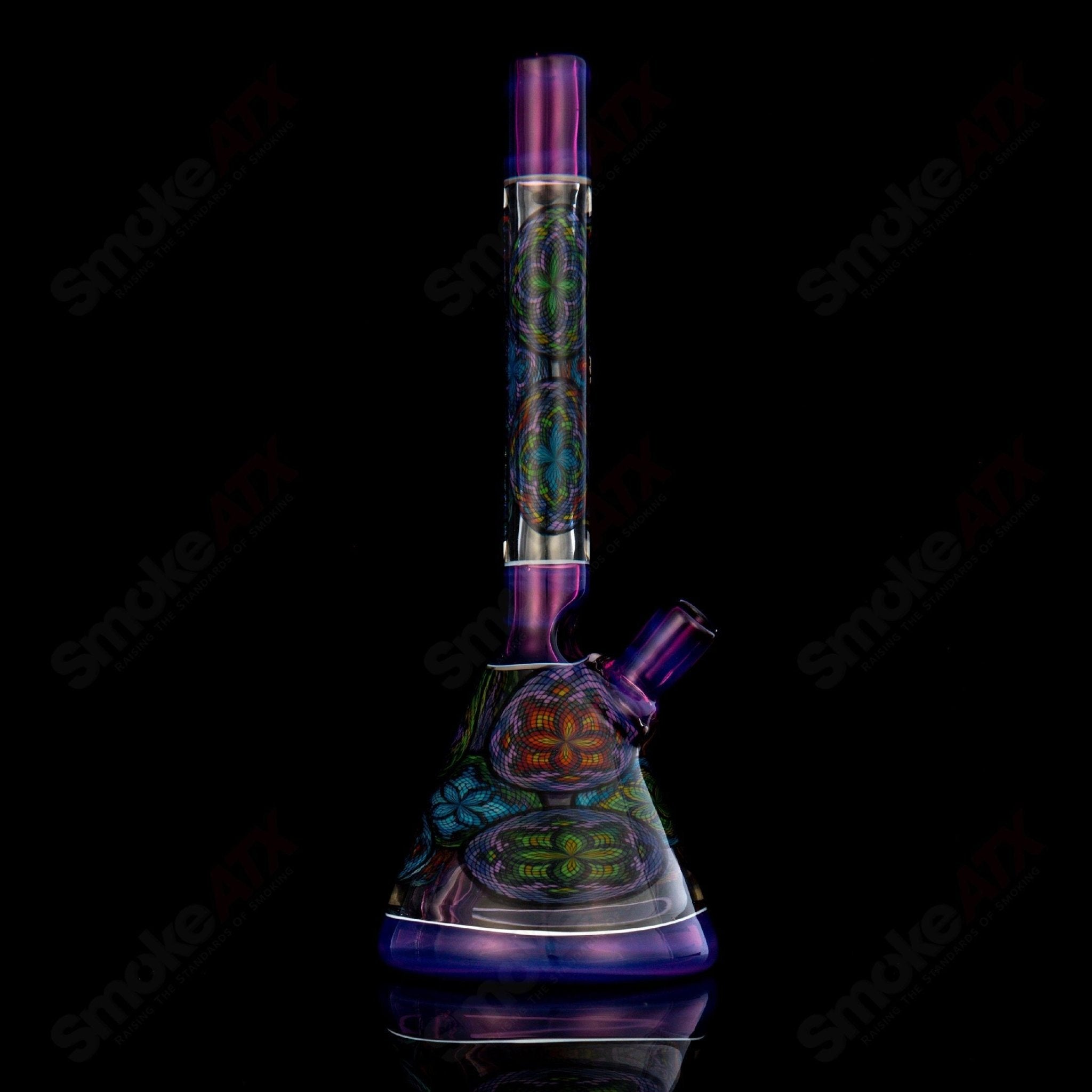 Multiple John W Glass Filla Beakers, colorful heady glass beakers with intricate designs, displayed together on a surface.