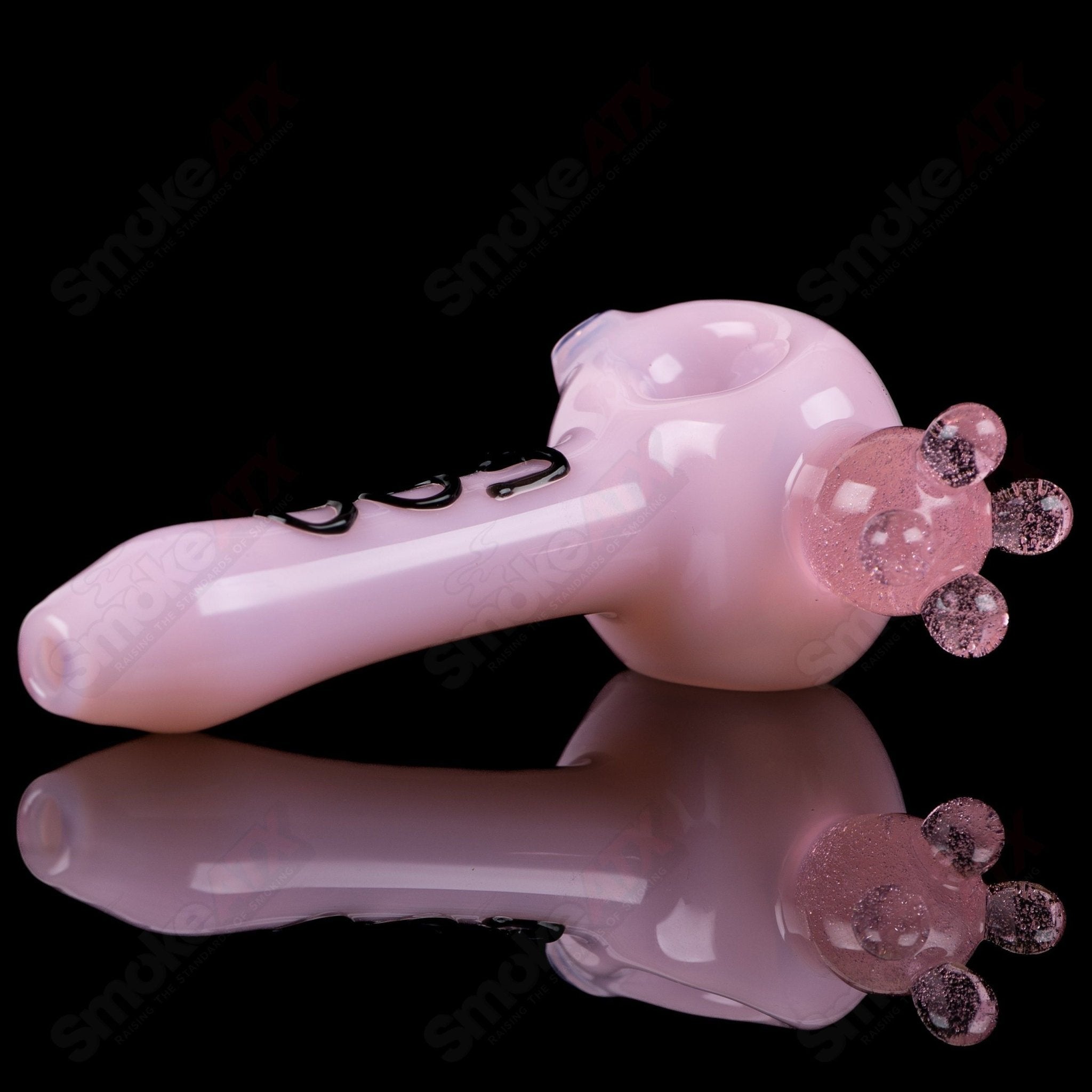 Pink cow print glass spoon pipe by Adventures In Glass Blowing, featuring a colorful, detailed design and smooth glass finish.