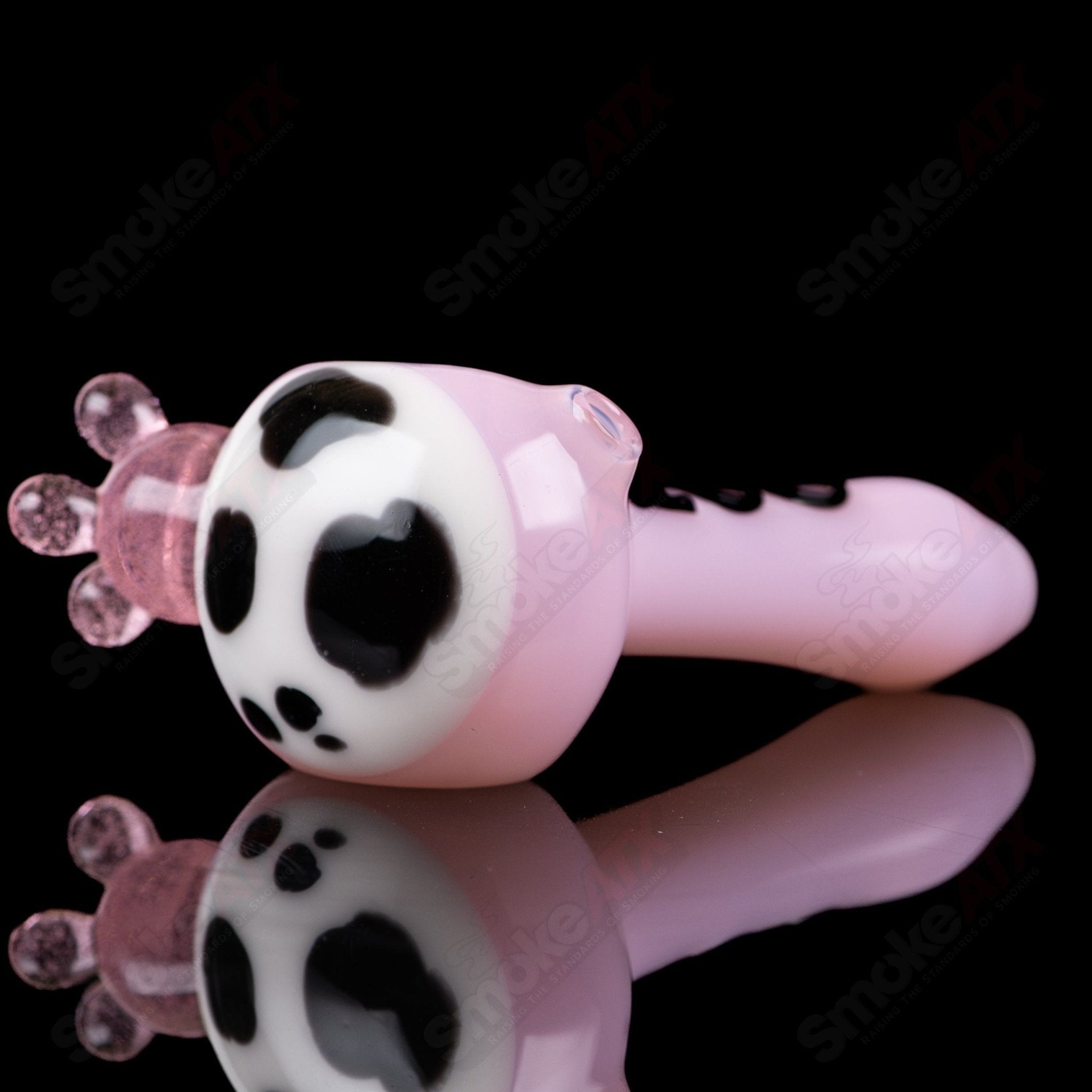 Pink cow print glass spoon pipe by Adventures In Glass Blowing, featuring colorful cow patterns and a smooth bowl design.
