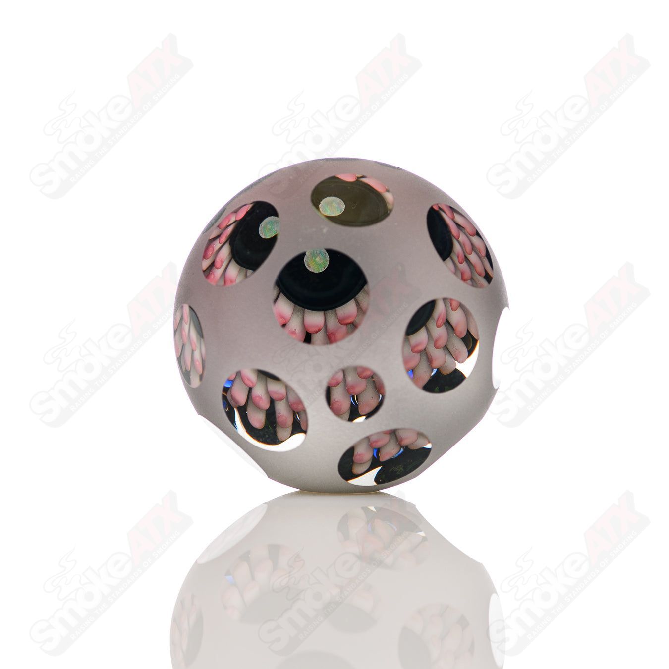 Pink faceted marble Raj K glass from Raj Kommineni Glass, featuring colorful glass marbles on a clear heady glass piece.