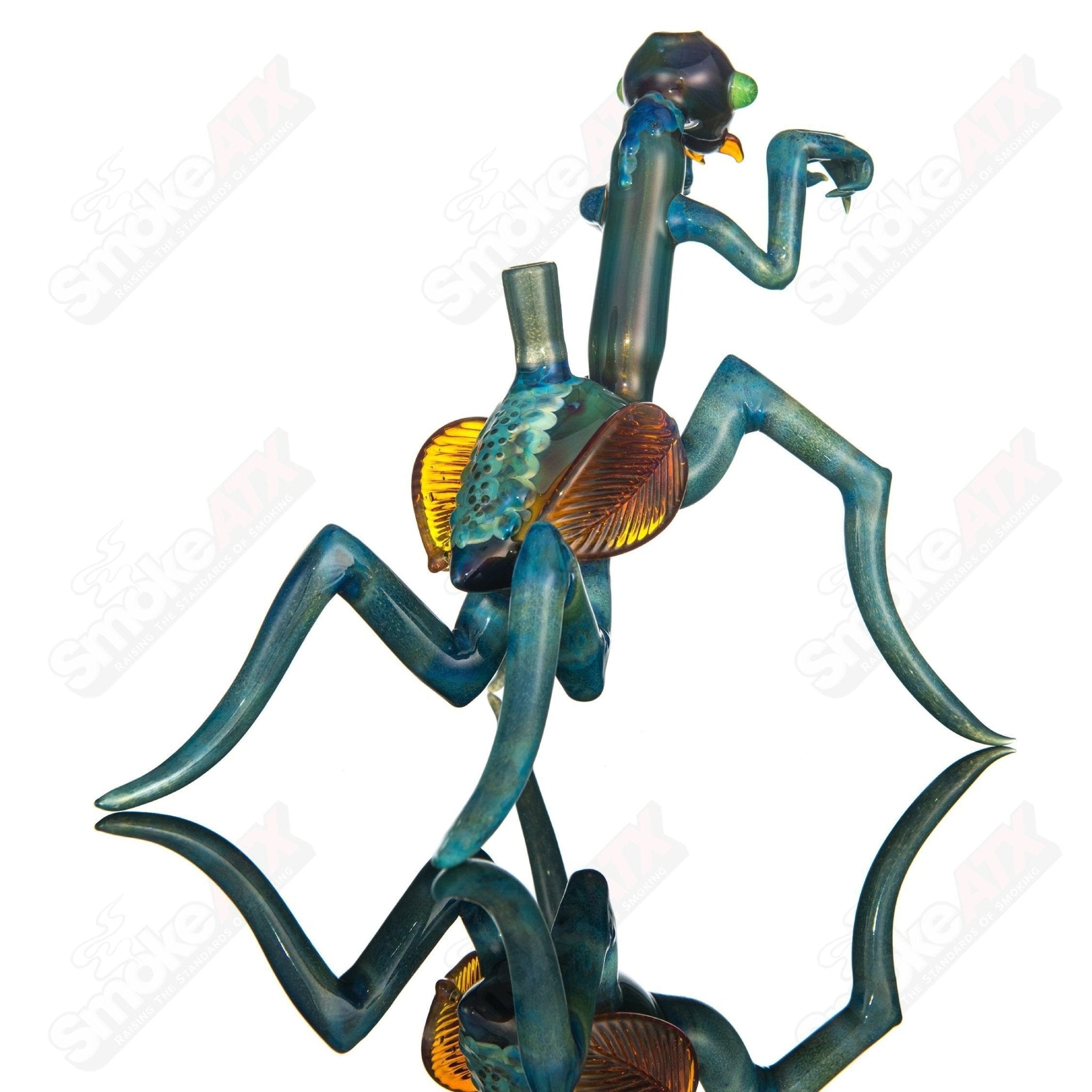 Salt Glass praying mantis rig Burtoni x SALT, heady glass concentrate rig with intricate mantis design and clear glass accents.