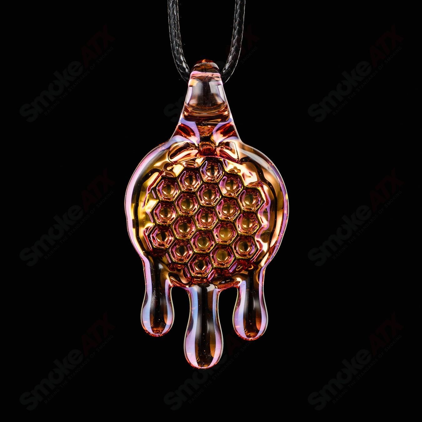 James Lang pressed honeycomb glass pendant hanging on a chain, showcasing intricate honeycomb pattern and vibrant amber color.