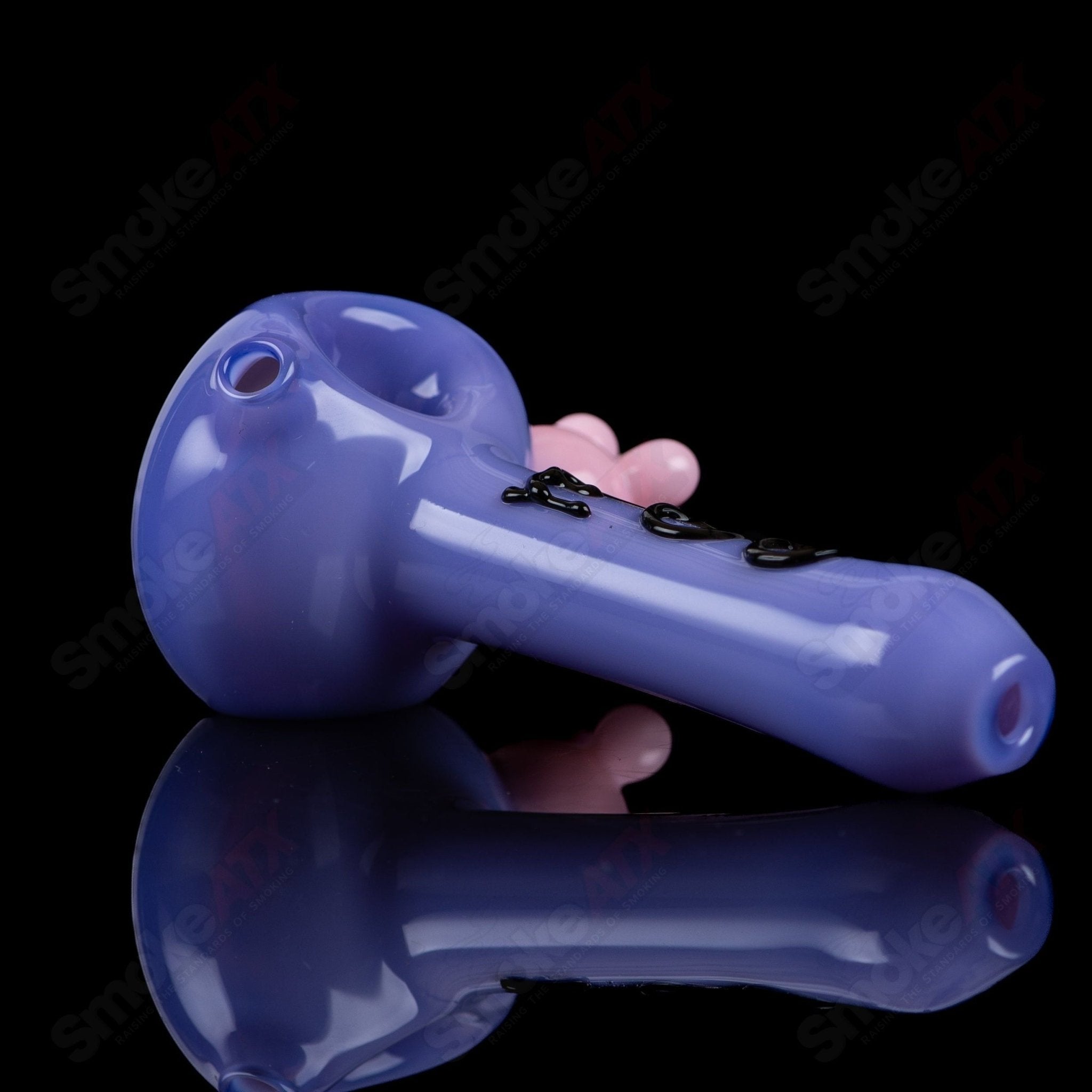 Purple cow print spoon pipe from Adventures In Glass Blowing, hand-blown glass pipe with vibrant purple cow design.