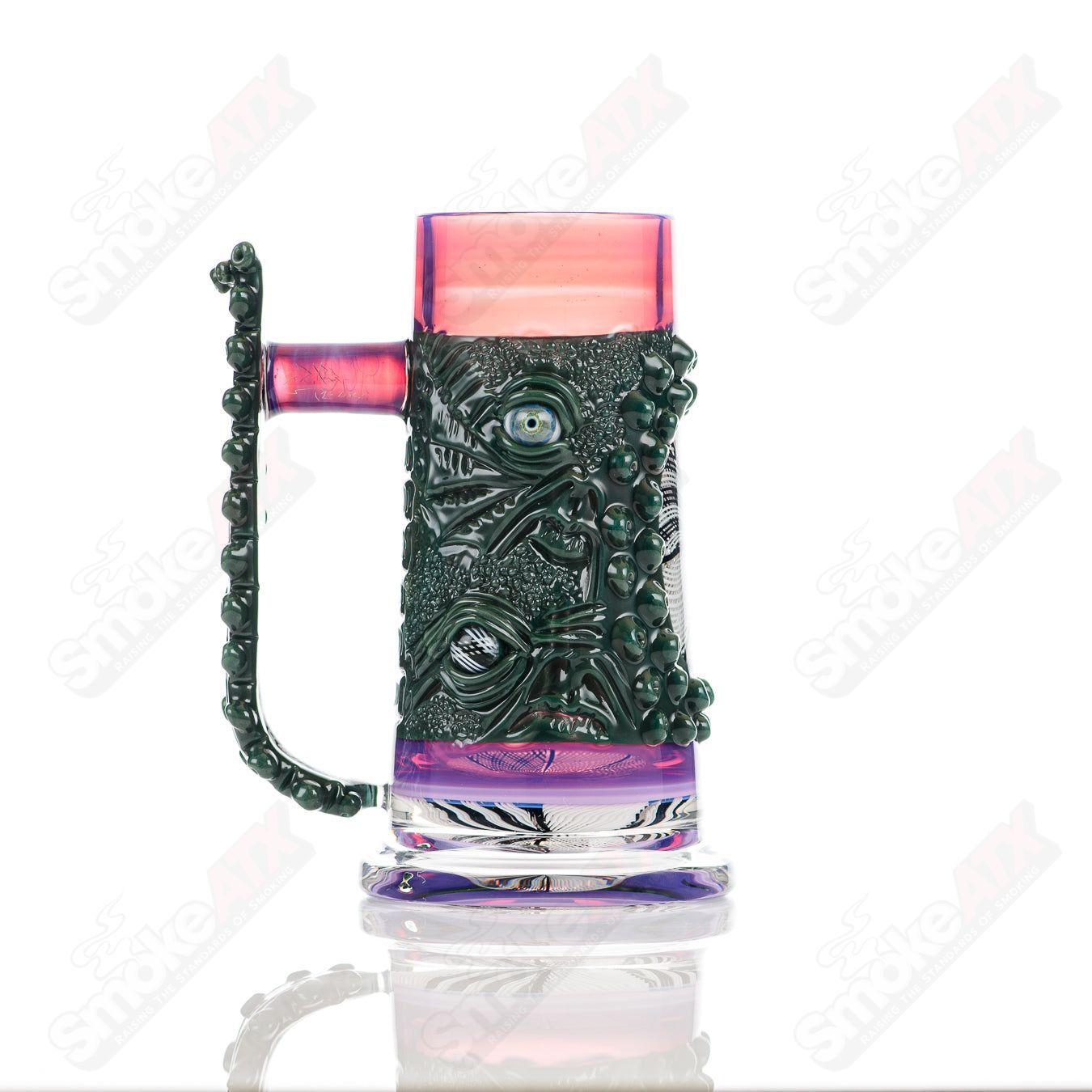 Reticello Many Face Drinking Mug by Salt Glass, a colorful heady glass cup with intricate reticello design and multiple face patterns.