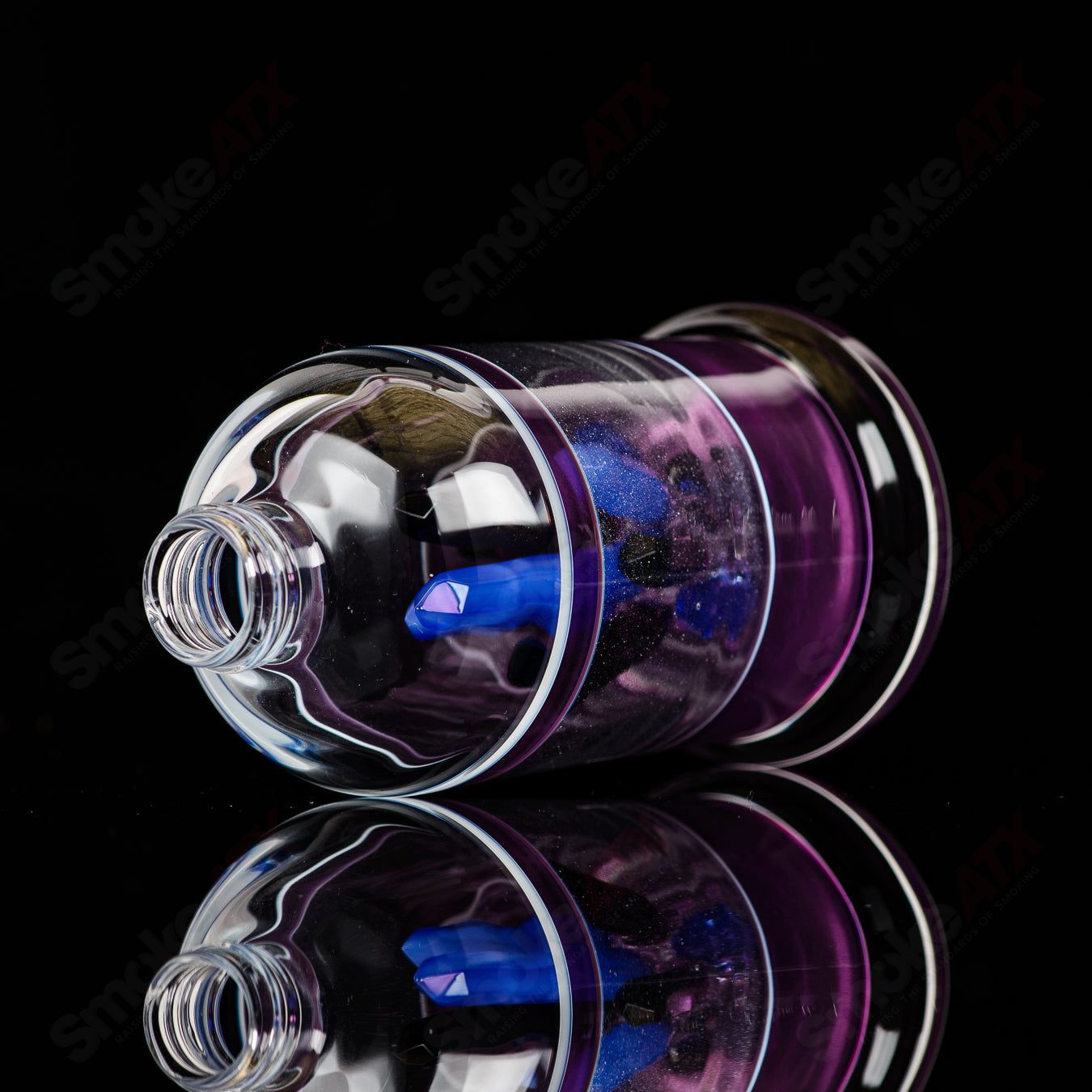 Northern Waters x SPG Heady Glass spray bottle featuring colorful artwork and a sleek, artistic glass design.