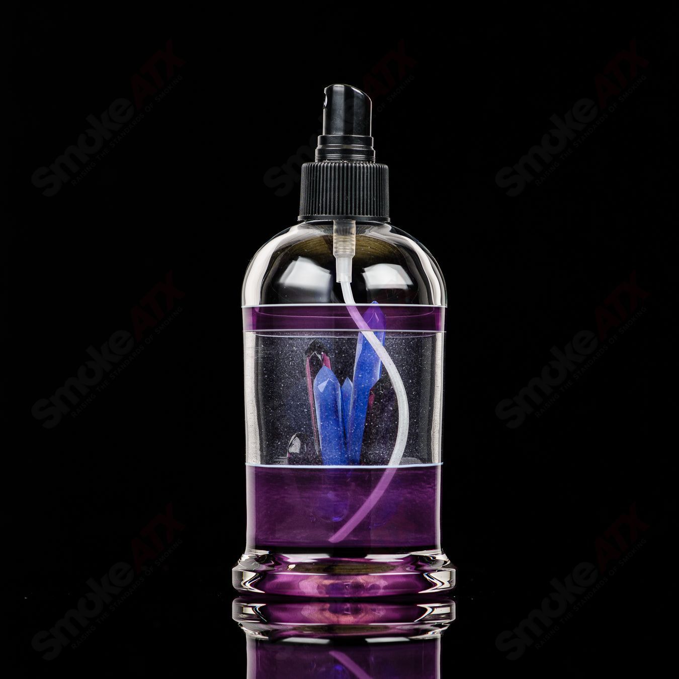 Heady glass spray bottle featuring Northern Waters x SPG artwork, with a sleek, transparent design and colorful glass accents.