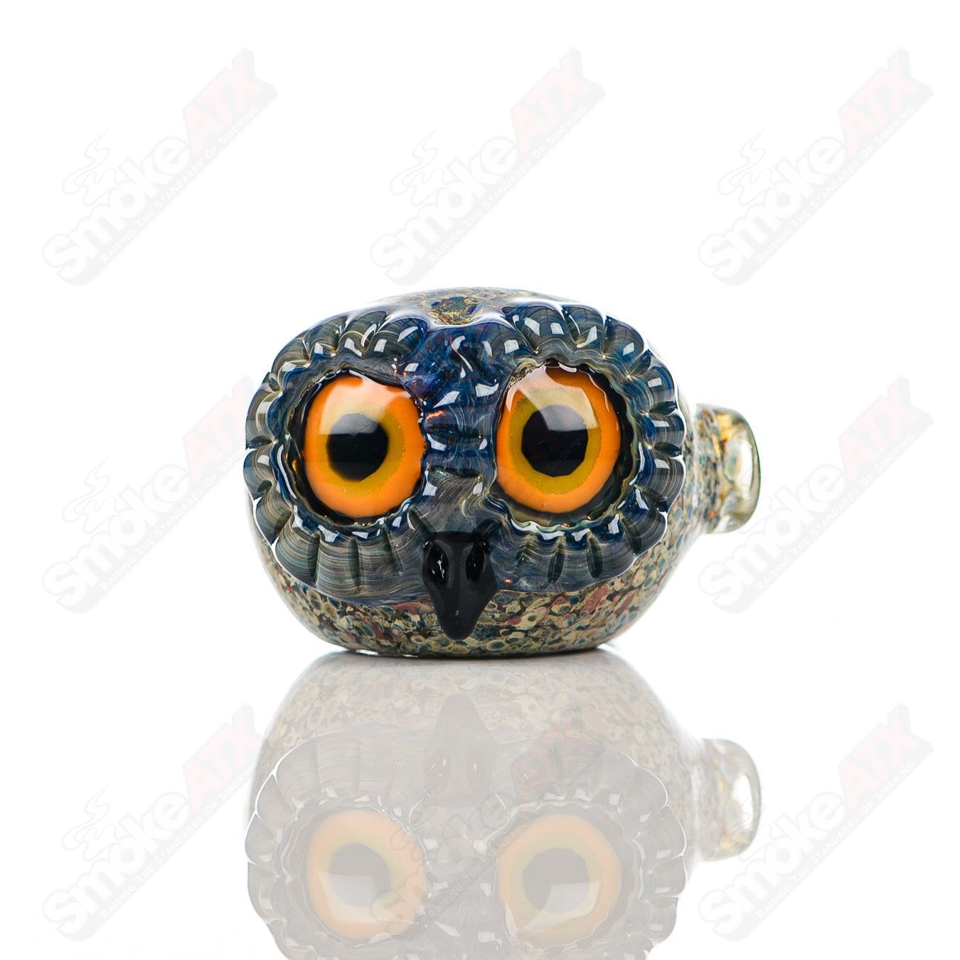 Glass pipe featuring a stone frit spotted owl design by Four Winds Flameworks, showcasing detailed craftsmanship and colorful accents.