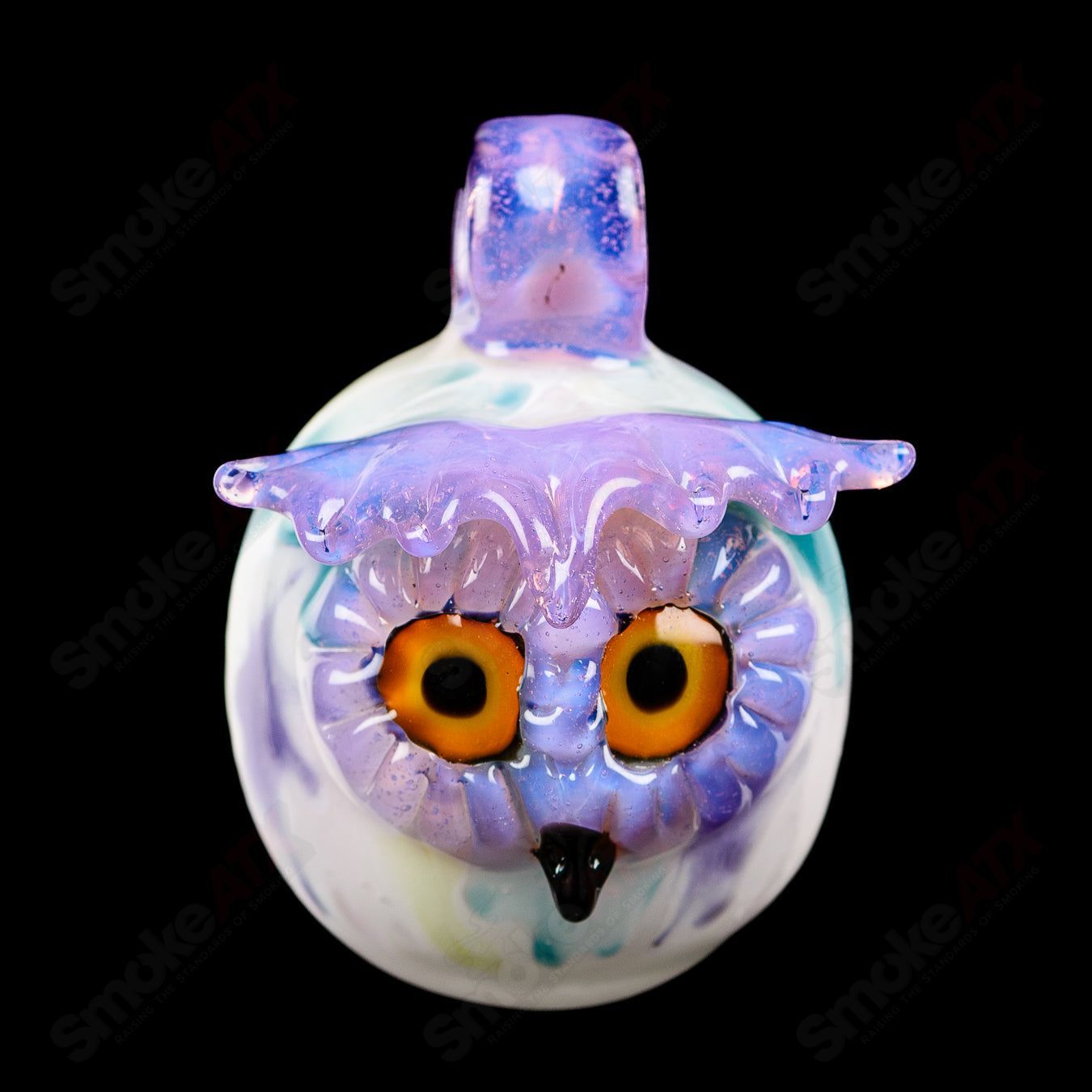 Colorful UV-reactive glass owl pendant by Four Winds Flameworks featuring splatter tech design, perfect for jewelry and accessories.