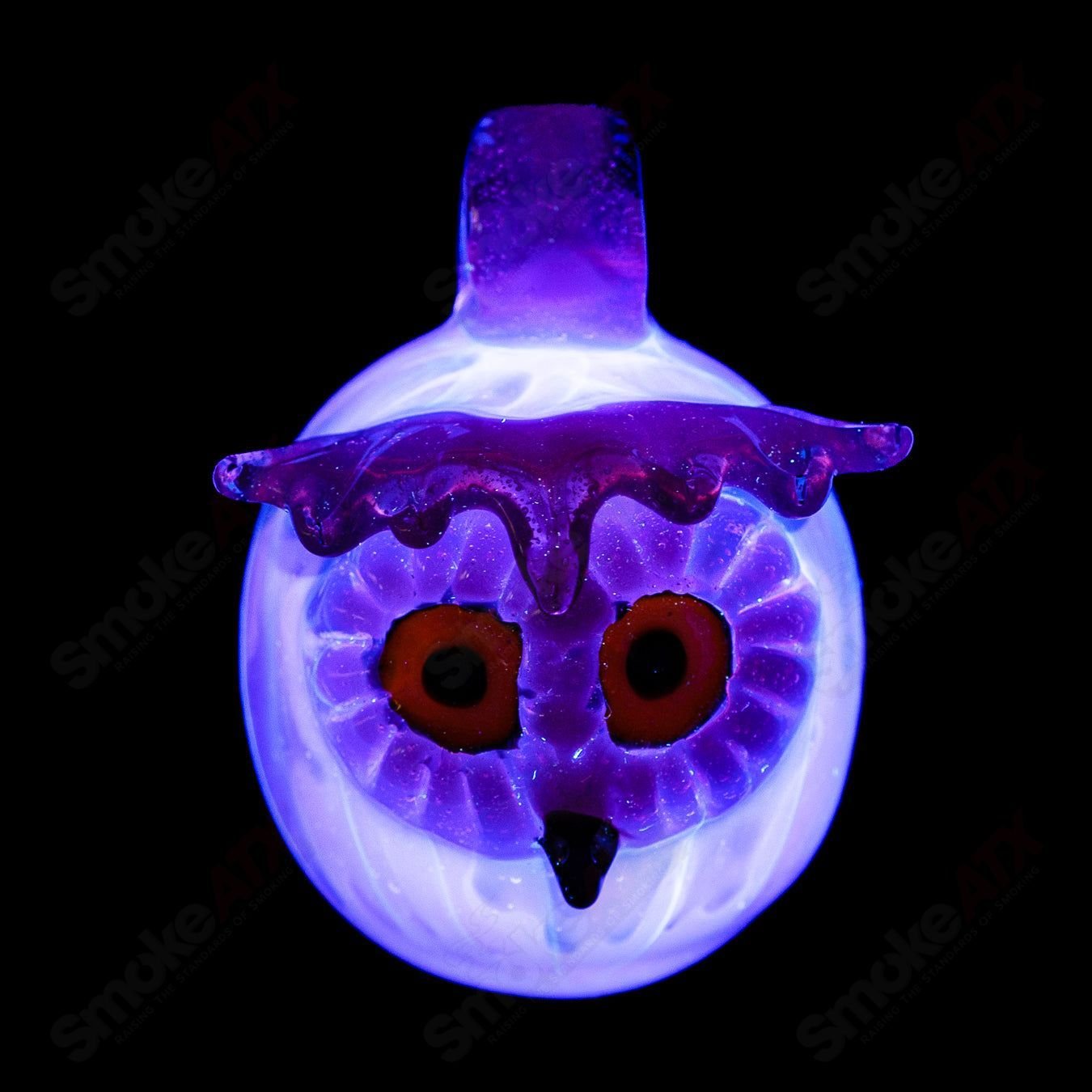 Colorful UV-reactive glass owl pendant by Four Winds Flameworks, featuring splatter and tech design, perfect for jewelry or accessories.