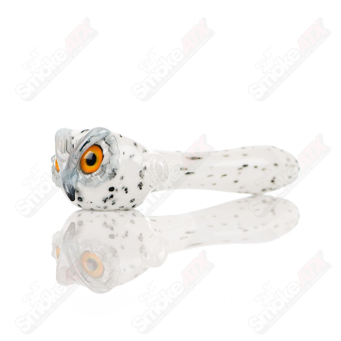 White spotted owl glass spoon pipe by Four Winds Flameworks, featuring intricate owl design and clear glass with white spots.