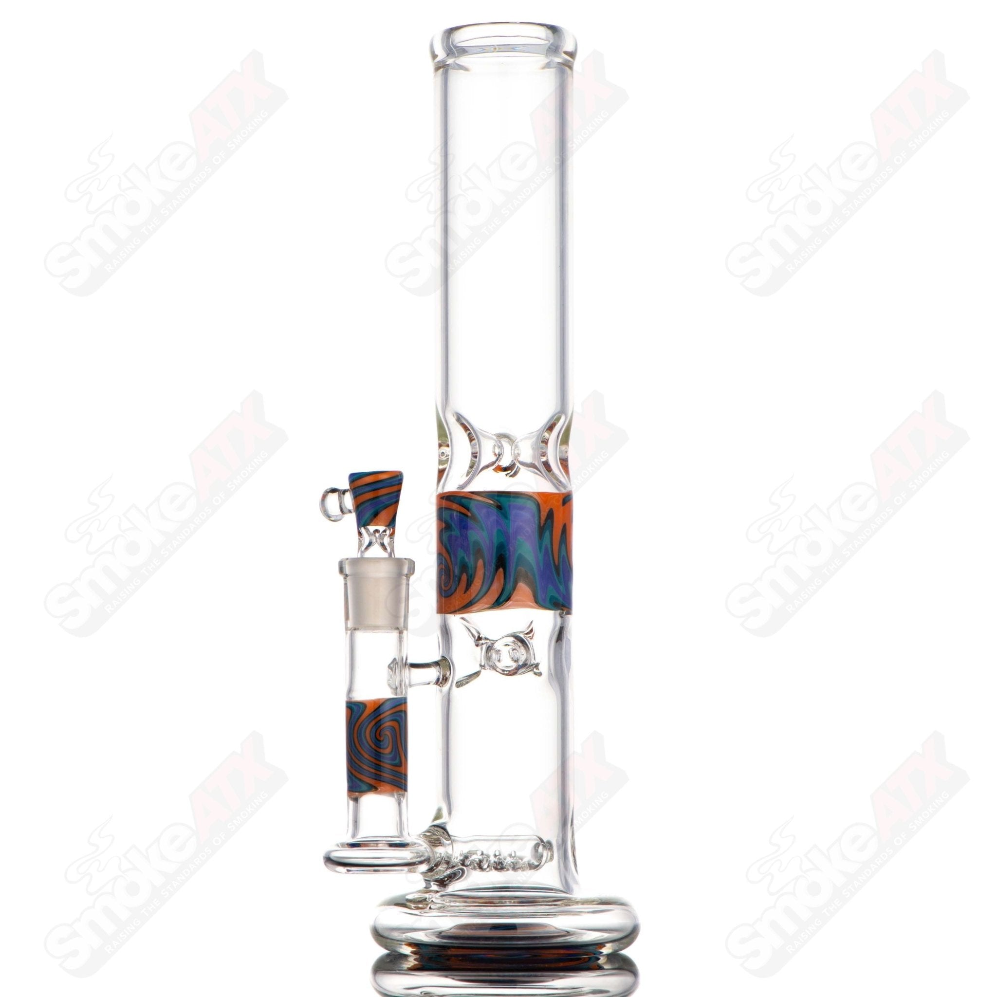Glass waterpipe by Texas Hot Glass featuring a WigWag Inline Hollowfoot design in vibrant orange, blue, and purple colors.