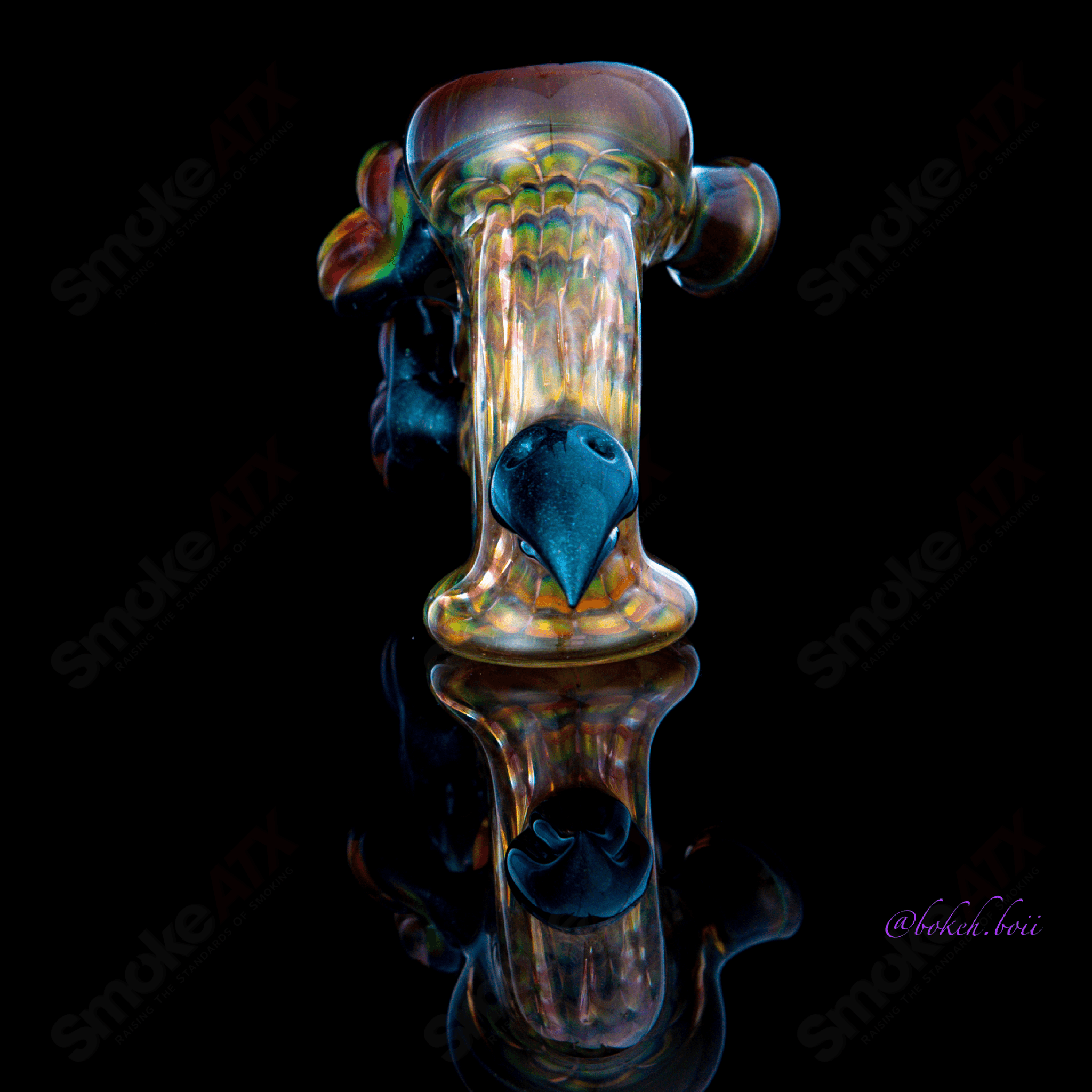 Handheld Wrap and Rake Dry Pipe by Calmbo X Dosh, featuring intricate glasswork and a sleek, portable design.